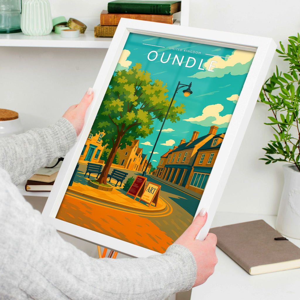 Oundle Travel Poster in a white frame, held to show scale