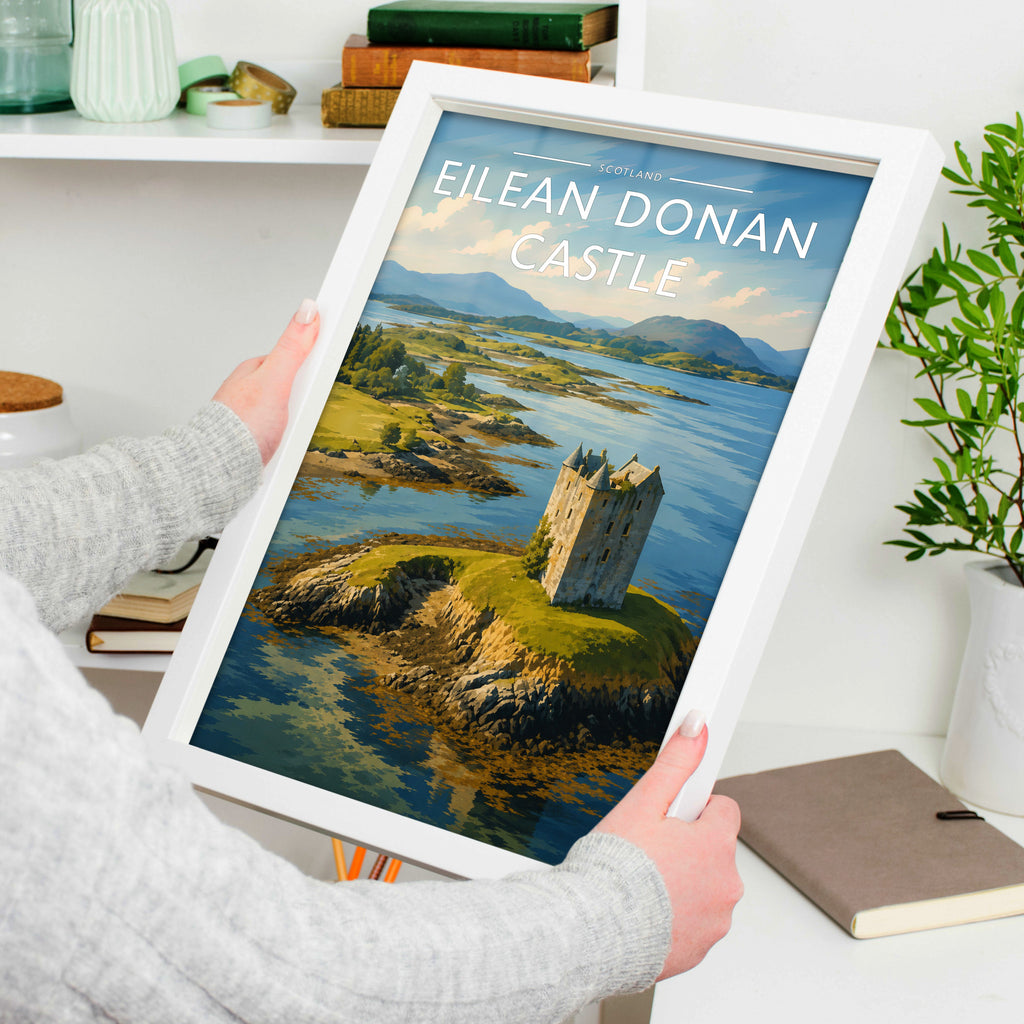 Eilean Donan Castle Travel Poster in a white frame, held to show scale