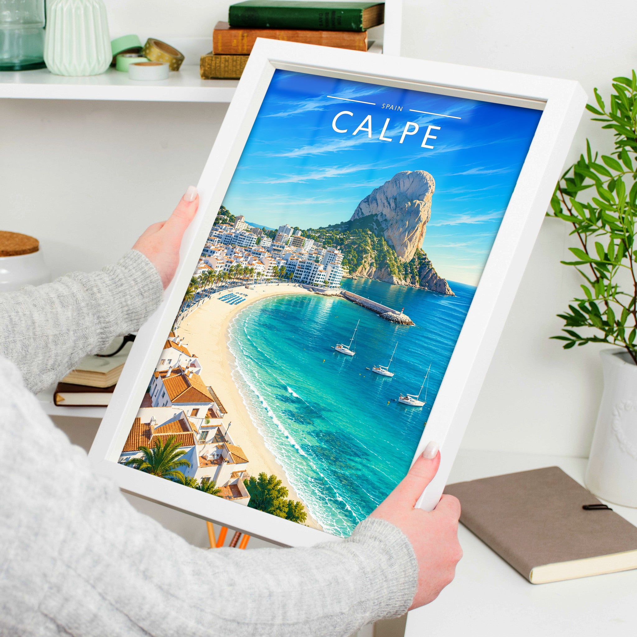 Calpe Travel Poster in a white frame, held to show scale