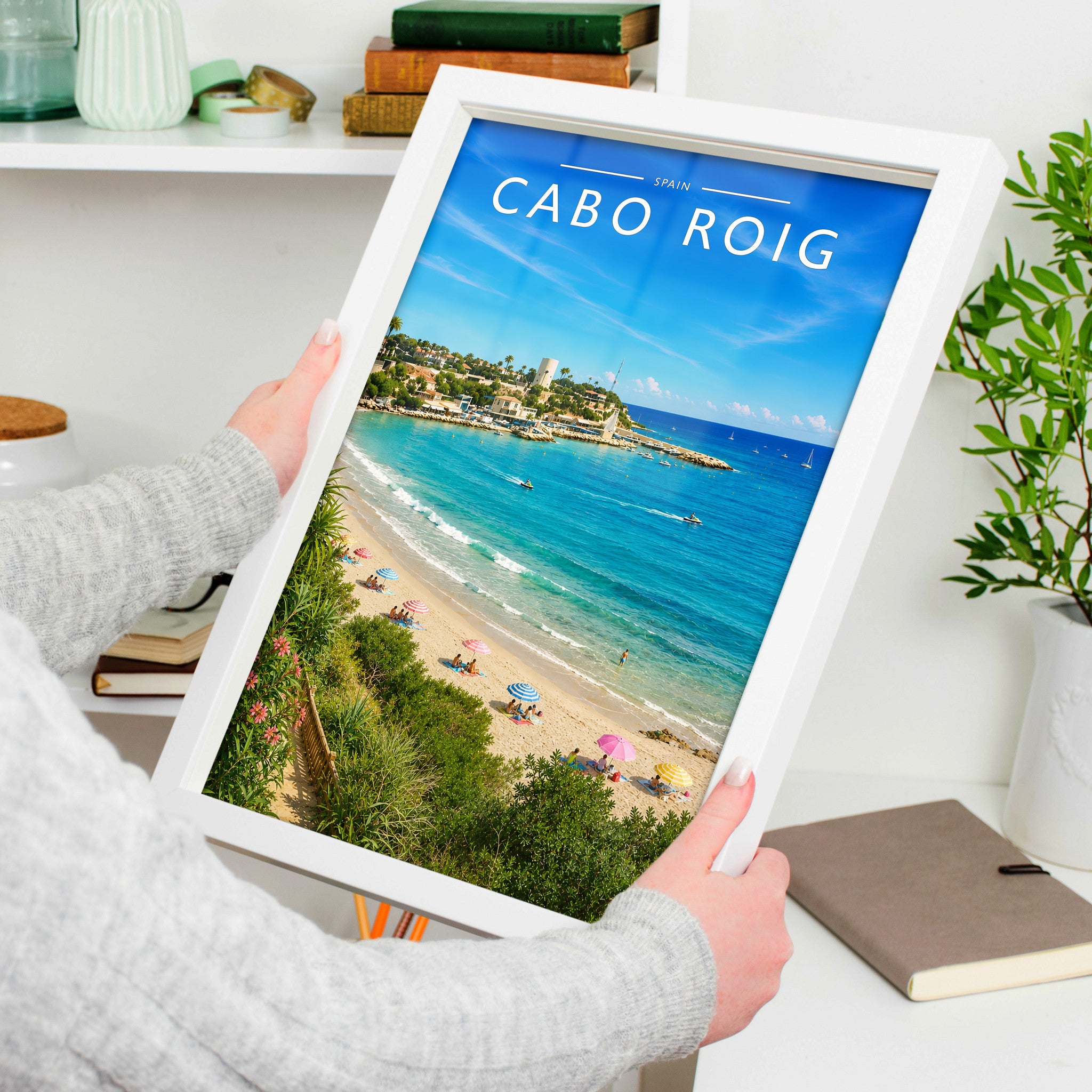 Cabo Roig Travel Poster in a white frame, held to show scale