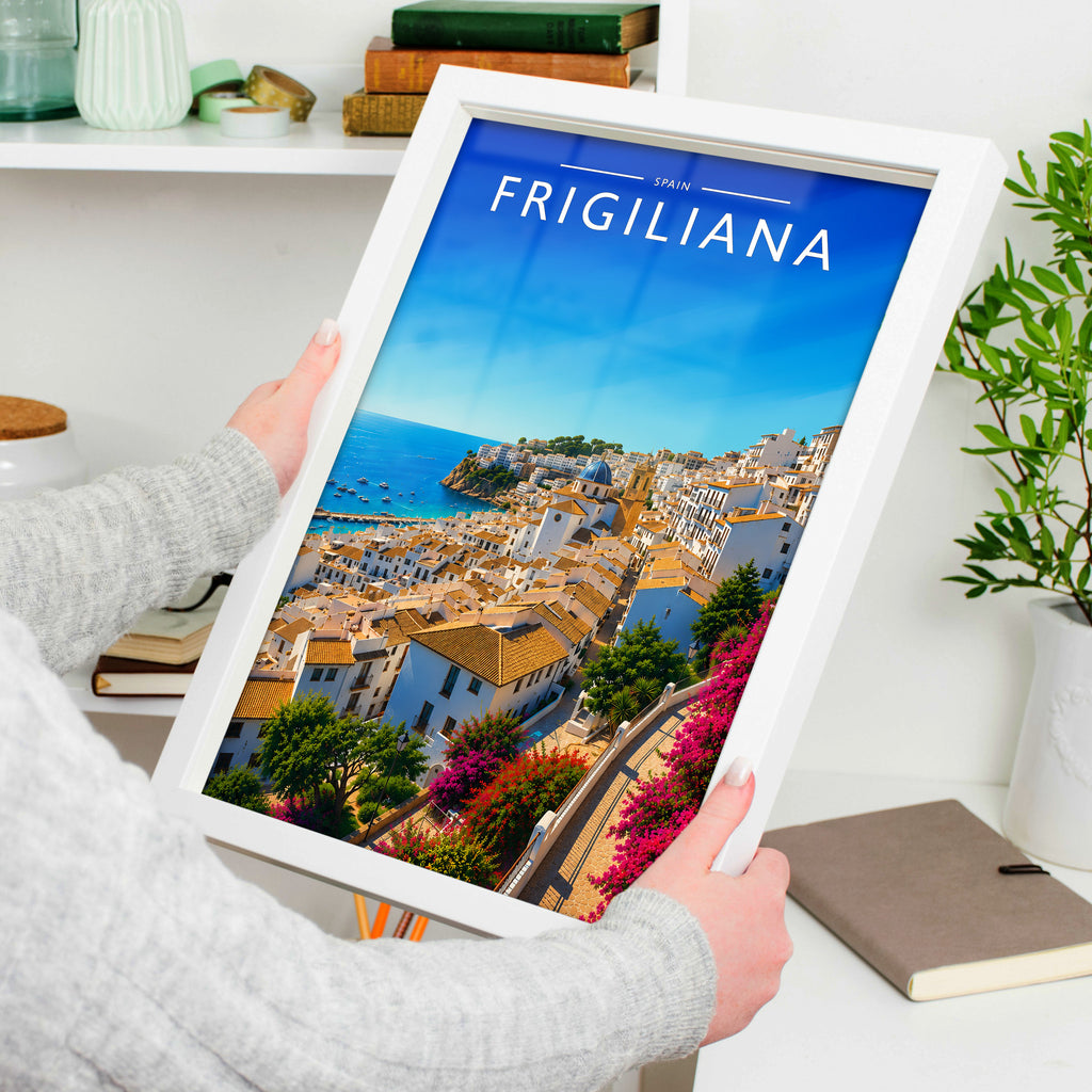 Frigiliana Travel Poster in a white frame, held to show scale