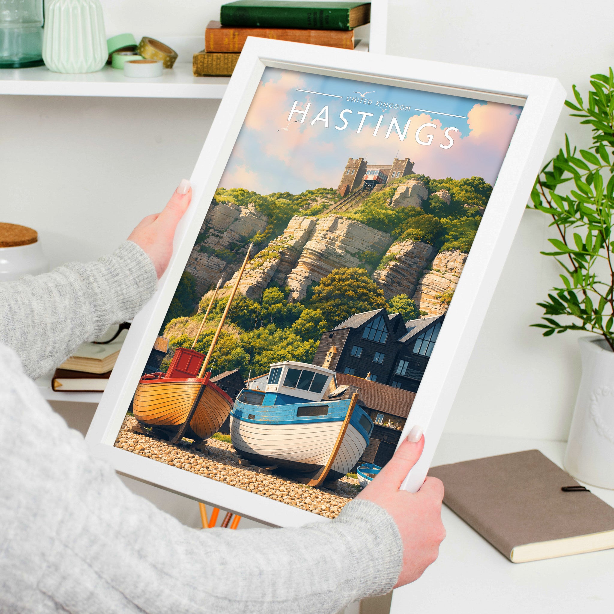 Hastings Travel Poster in a white frame, held to show scale