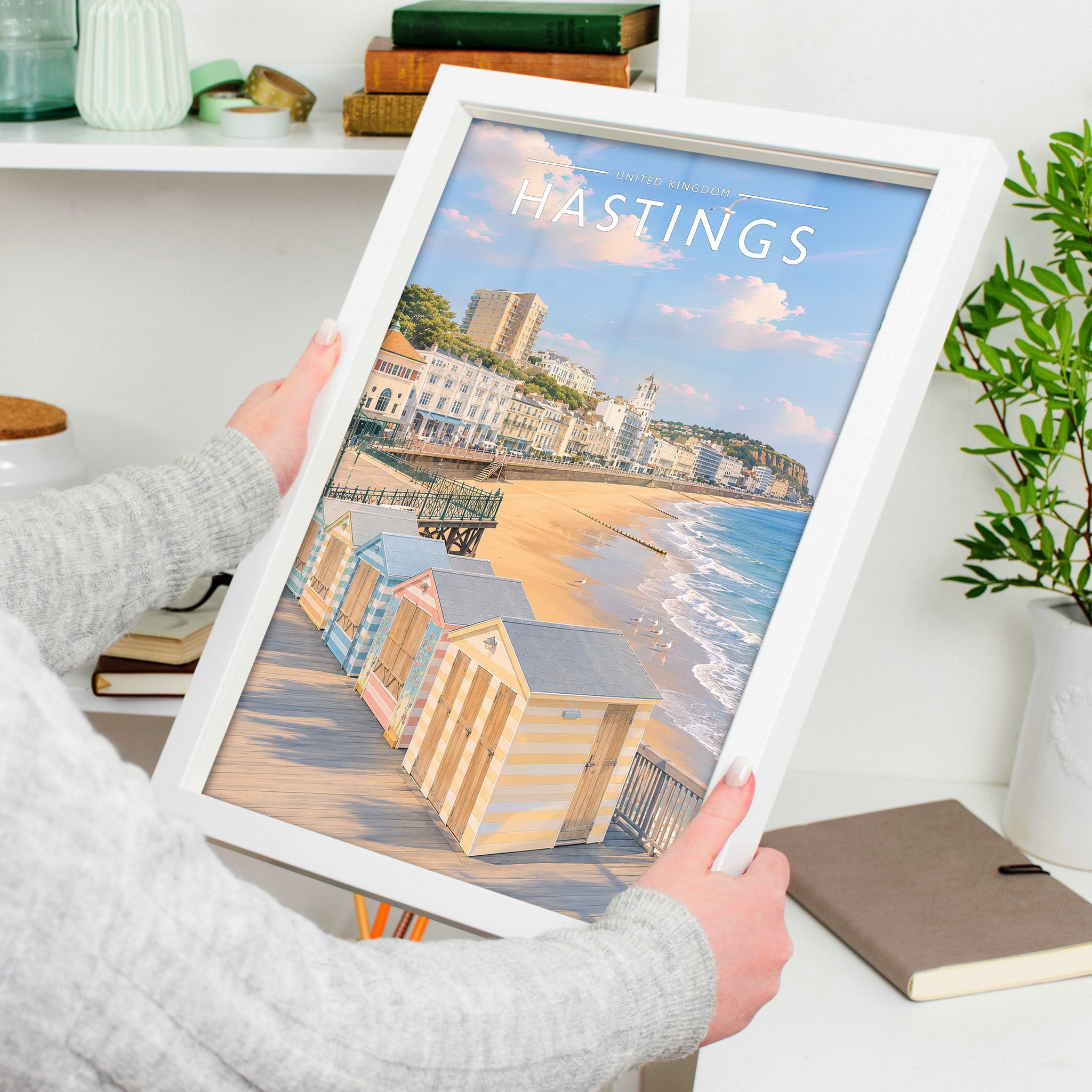 Hastings #2 Travel Poster in a white frame, held to show scale