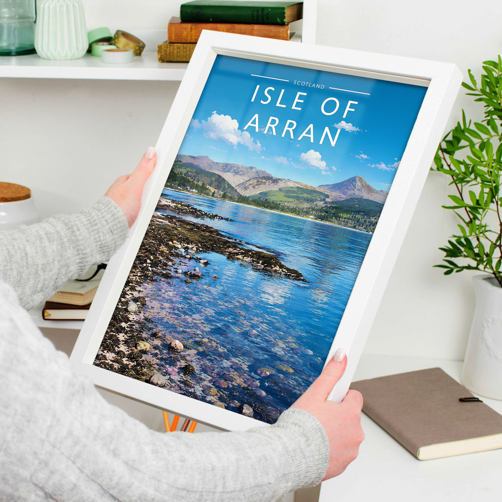 Isle of Arran Travel Poster in a white frame, held to show scale