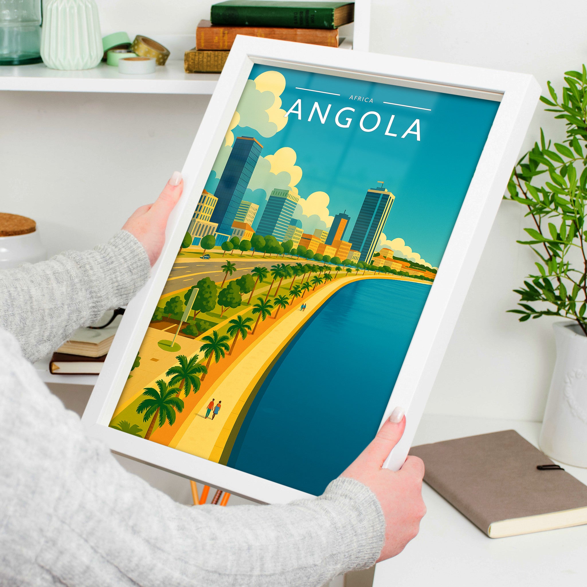 Angola Travel Poster in a white frame, held to show scale