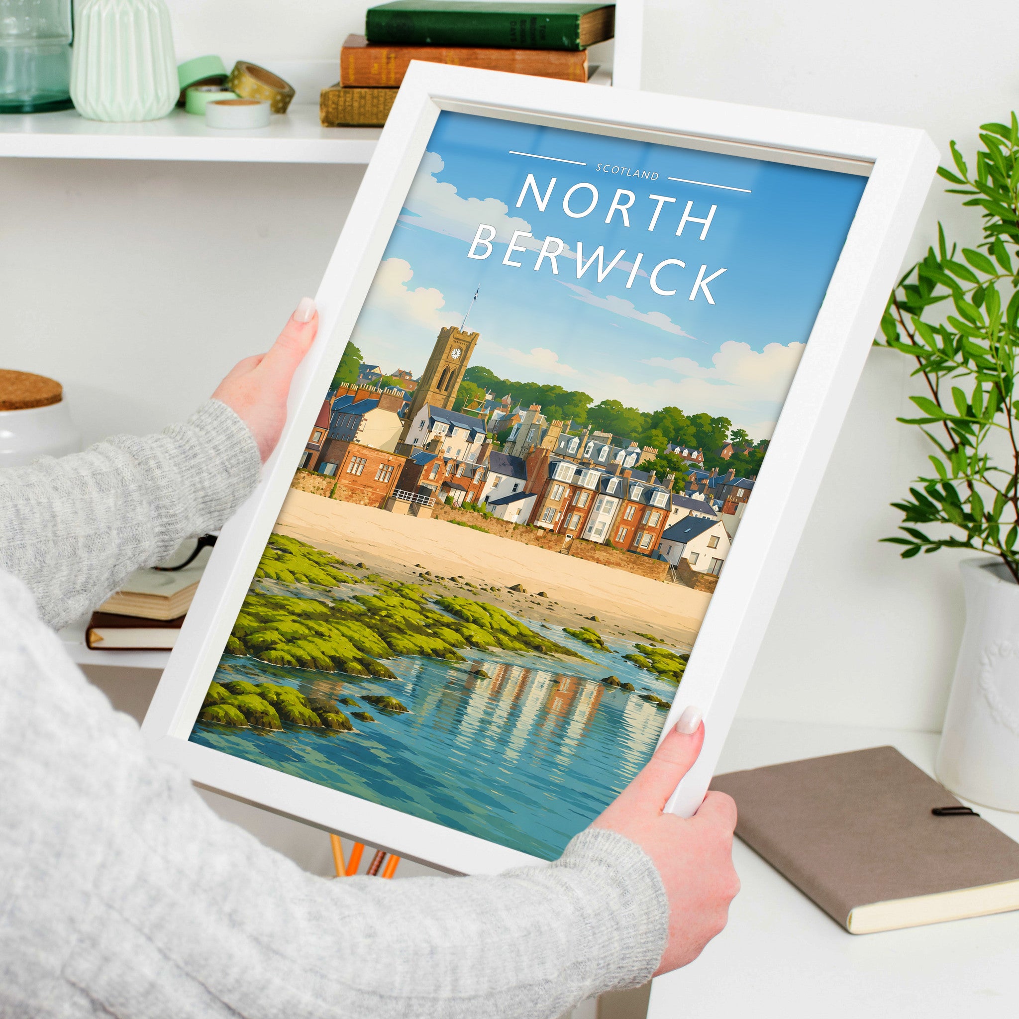 North Berwick #2 Travel Poster in a white frame, held to show scale