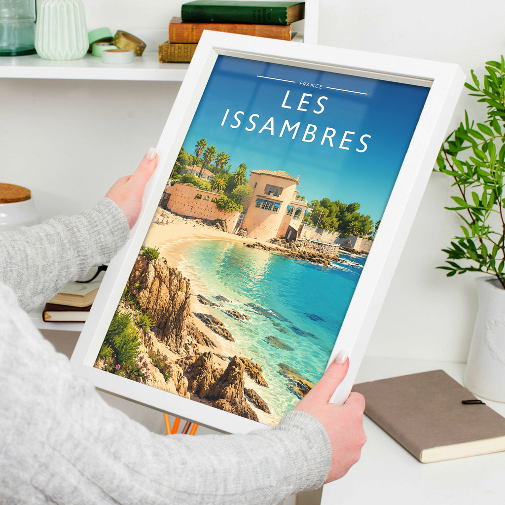 Les Issambres Travel Poster in a white frame, held to show scale