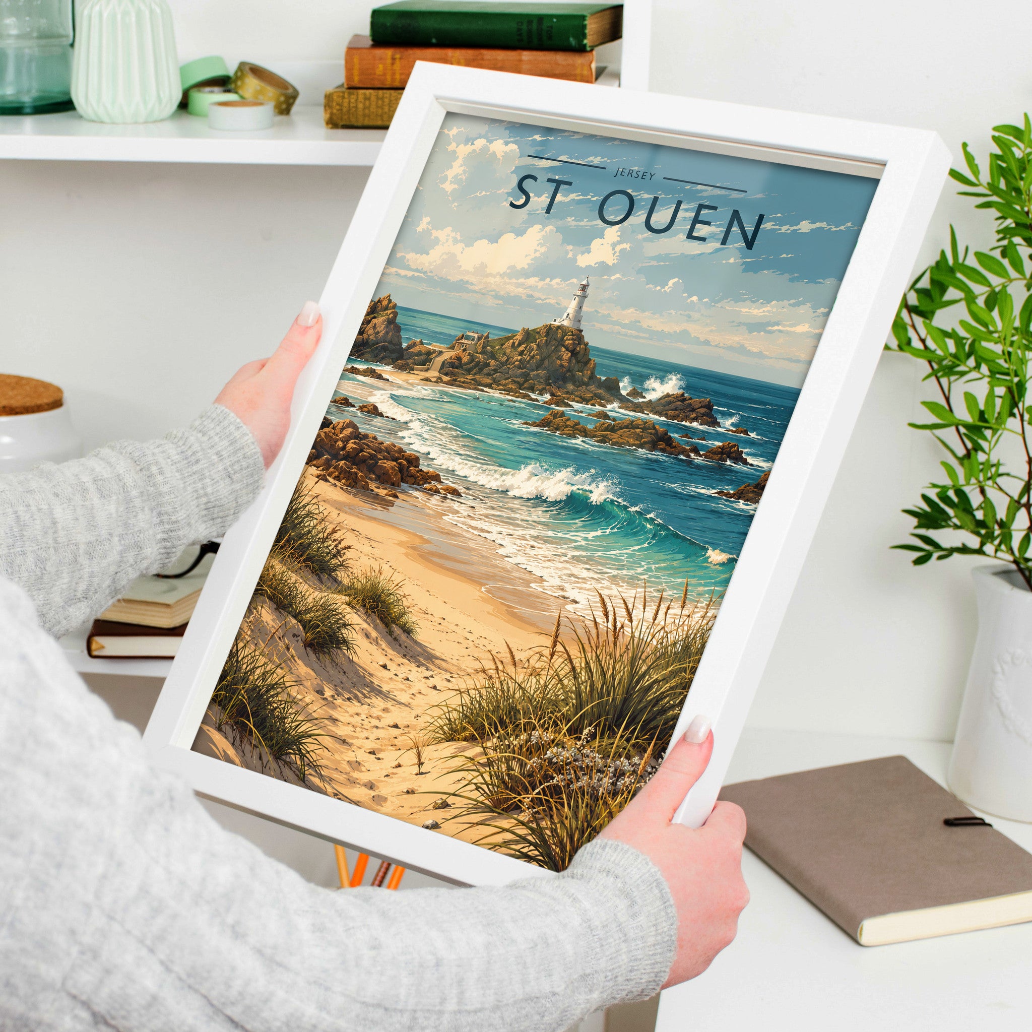 St Ouen Travel Poster in a white frame, held to show scale