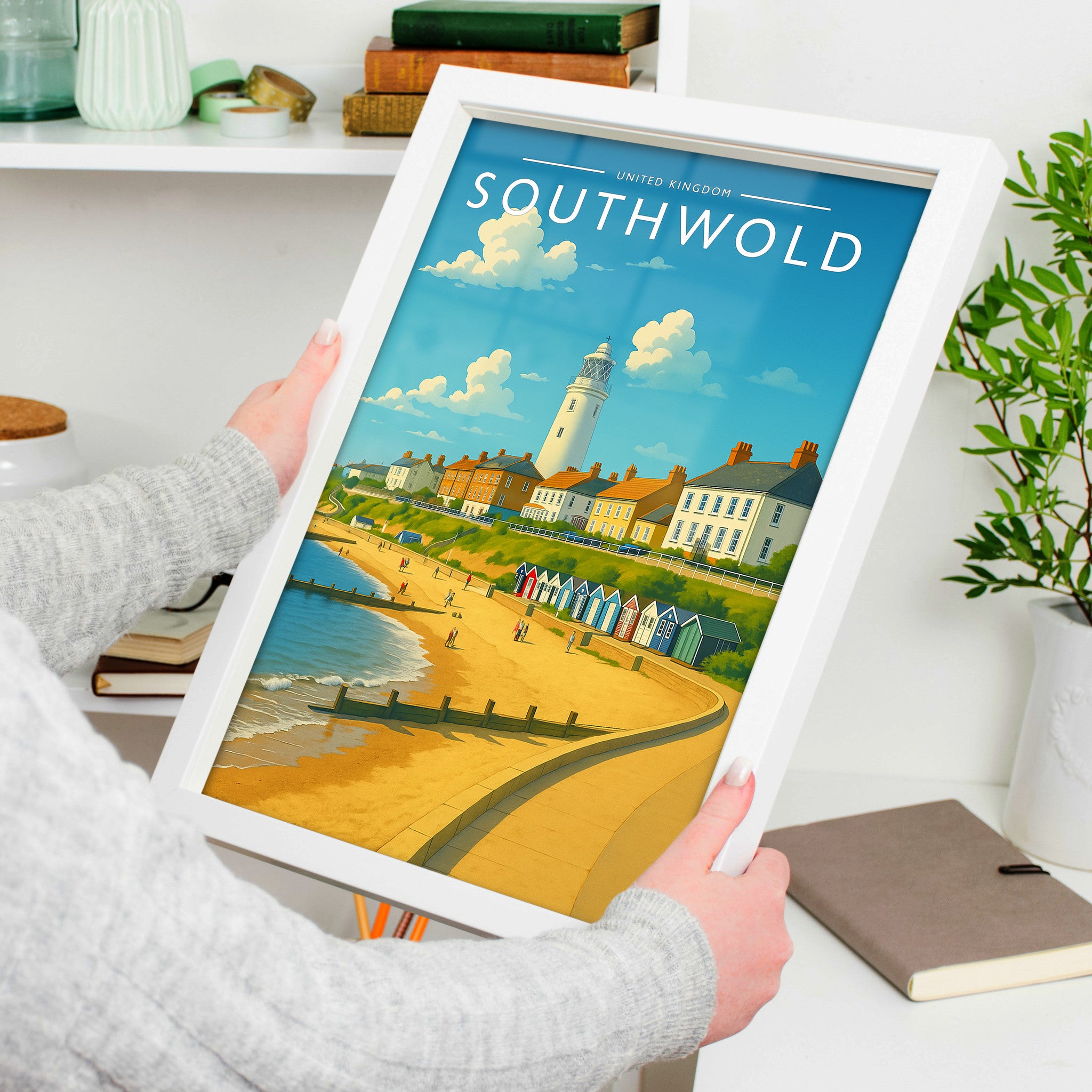 Southwold Travel Poster in a white frame, held to show scale