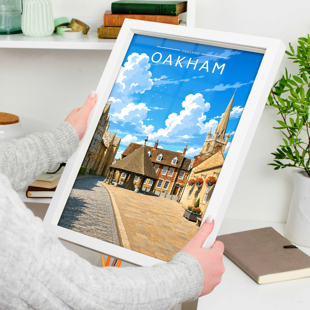 Oakham Travel Poster in a white frame, held to show scale