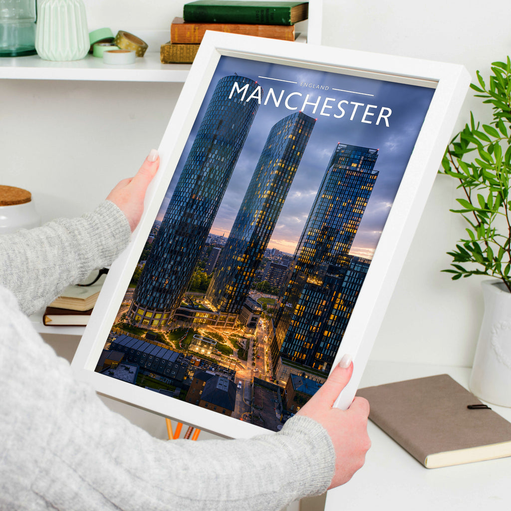 Manchester Travel Poster in a white frame, held to show scale