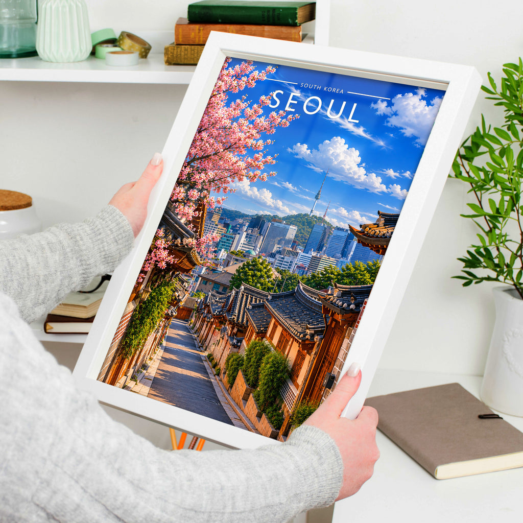 Seoul Travel Poster in a white frame, held to show scale