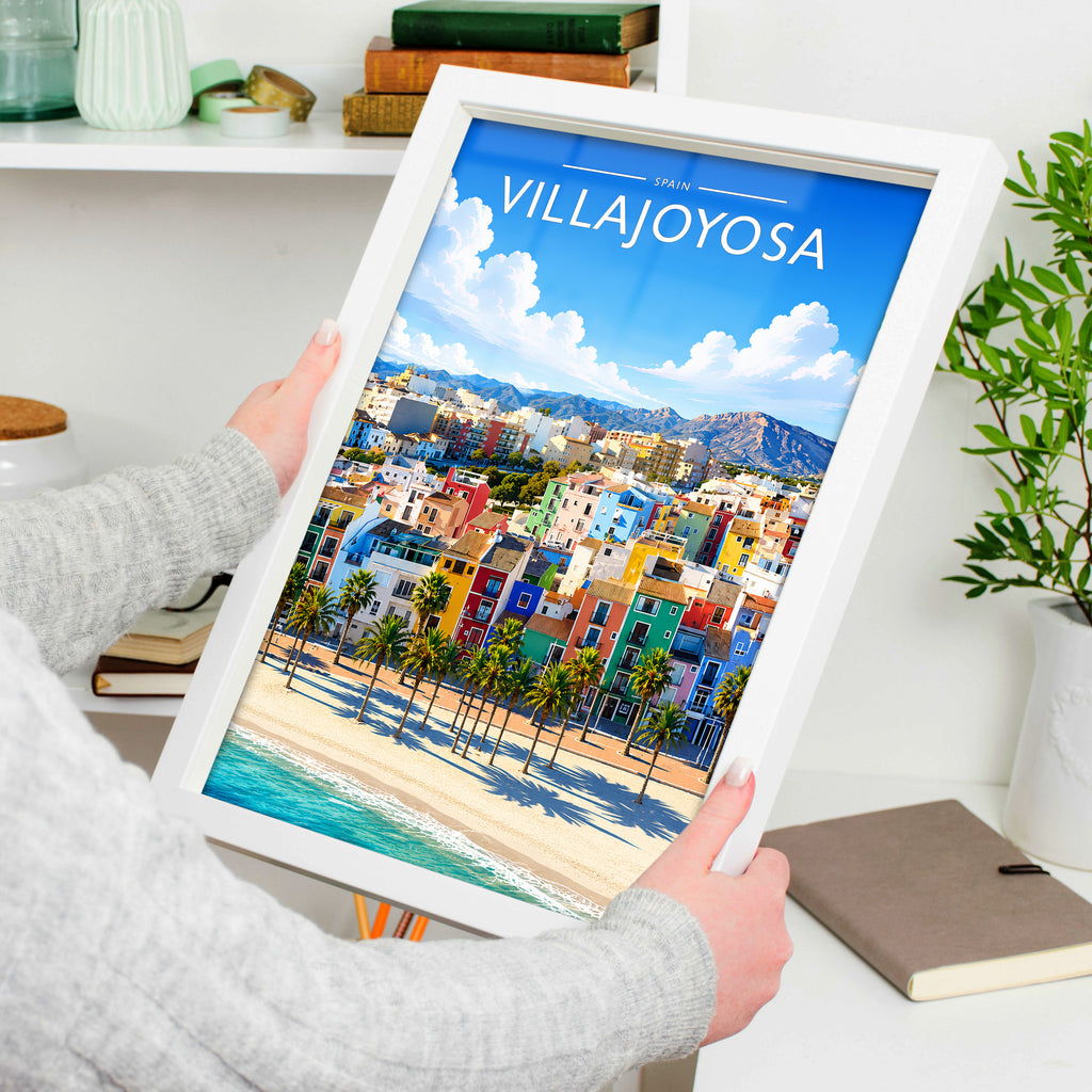 Villajoyosa Travel Poster in a white frame, held to show scale