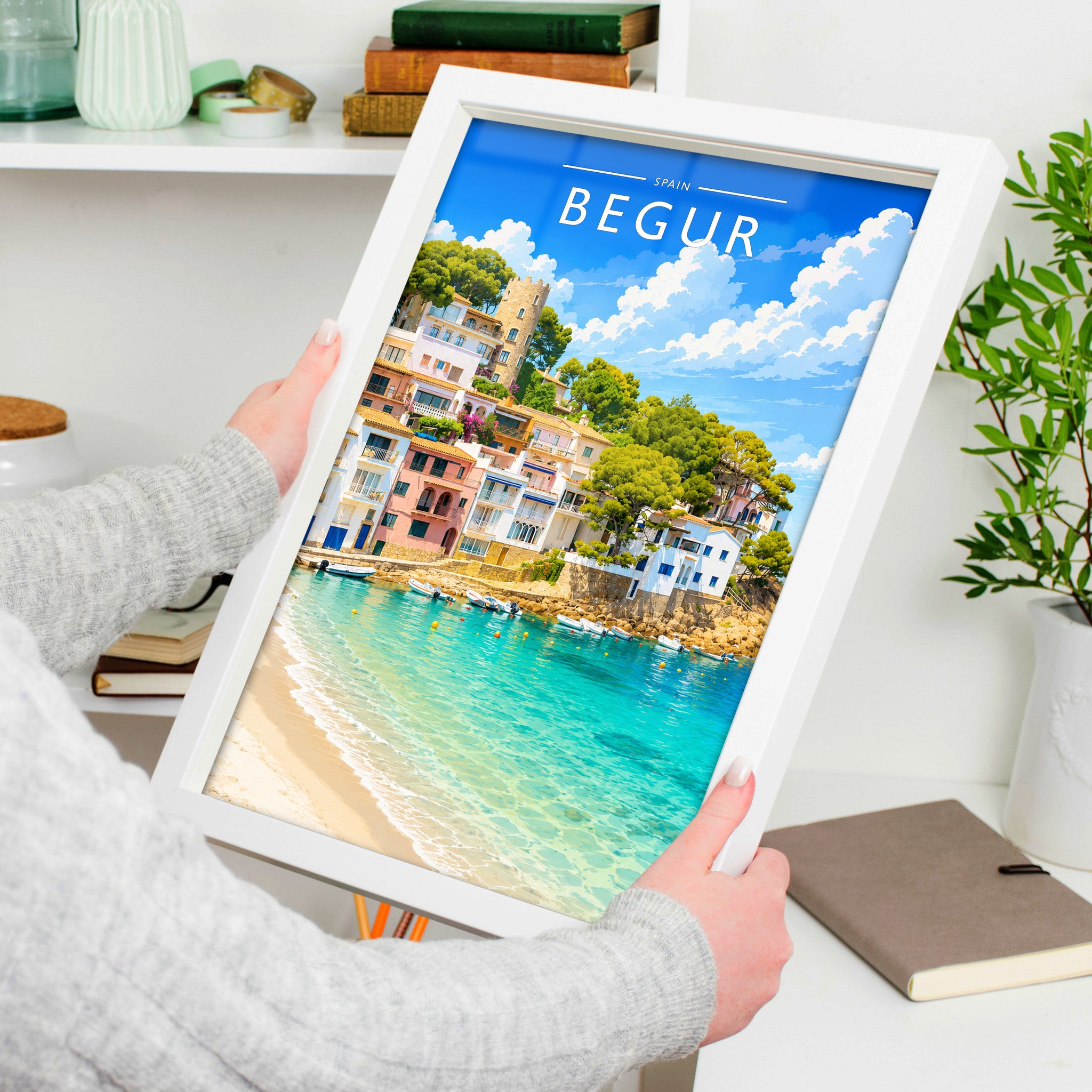 Begur Travel Poster in a white frame, held to show scale