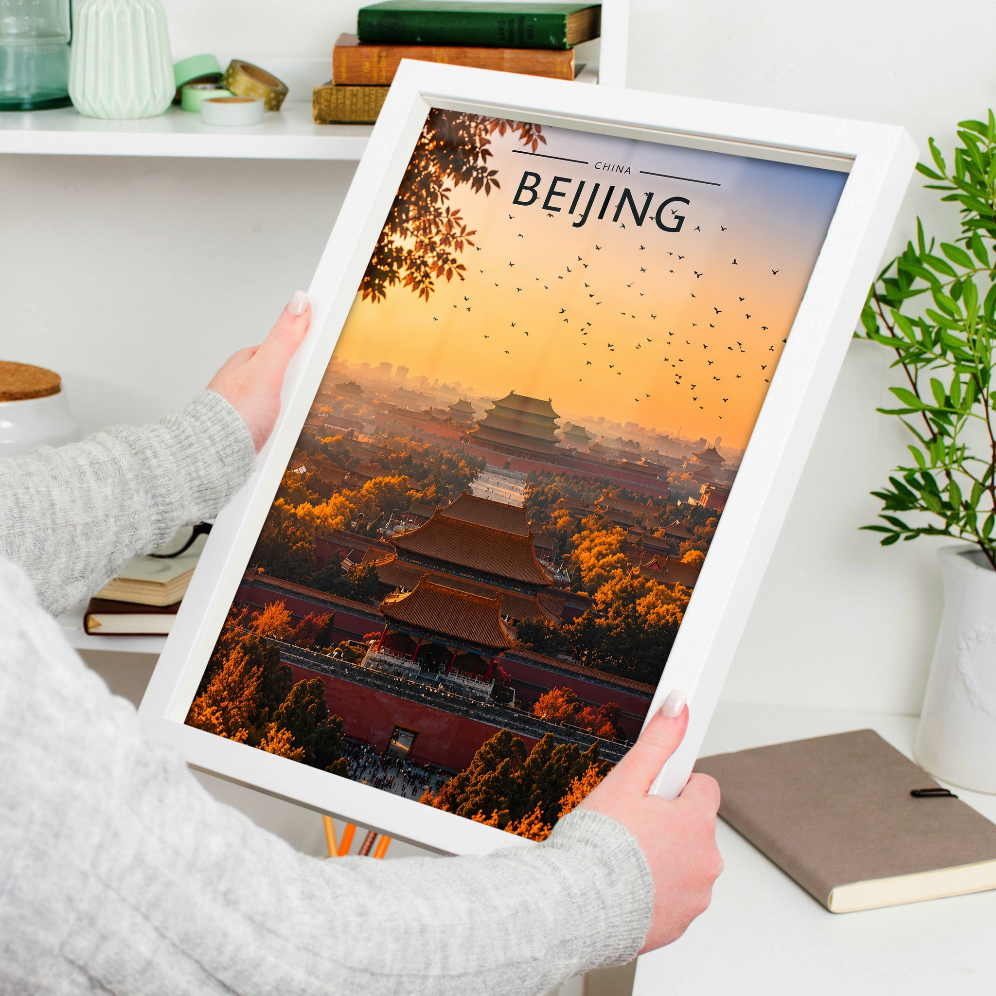 Beijing Travel Poster in a white frame, held to show scale