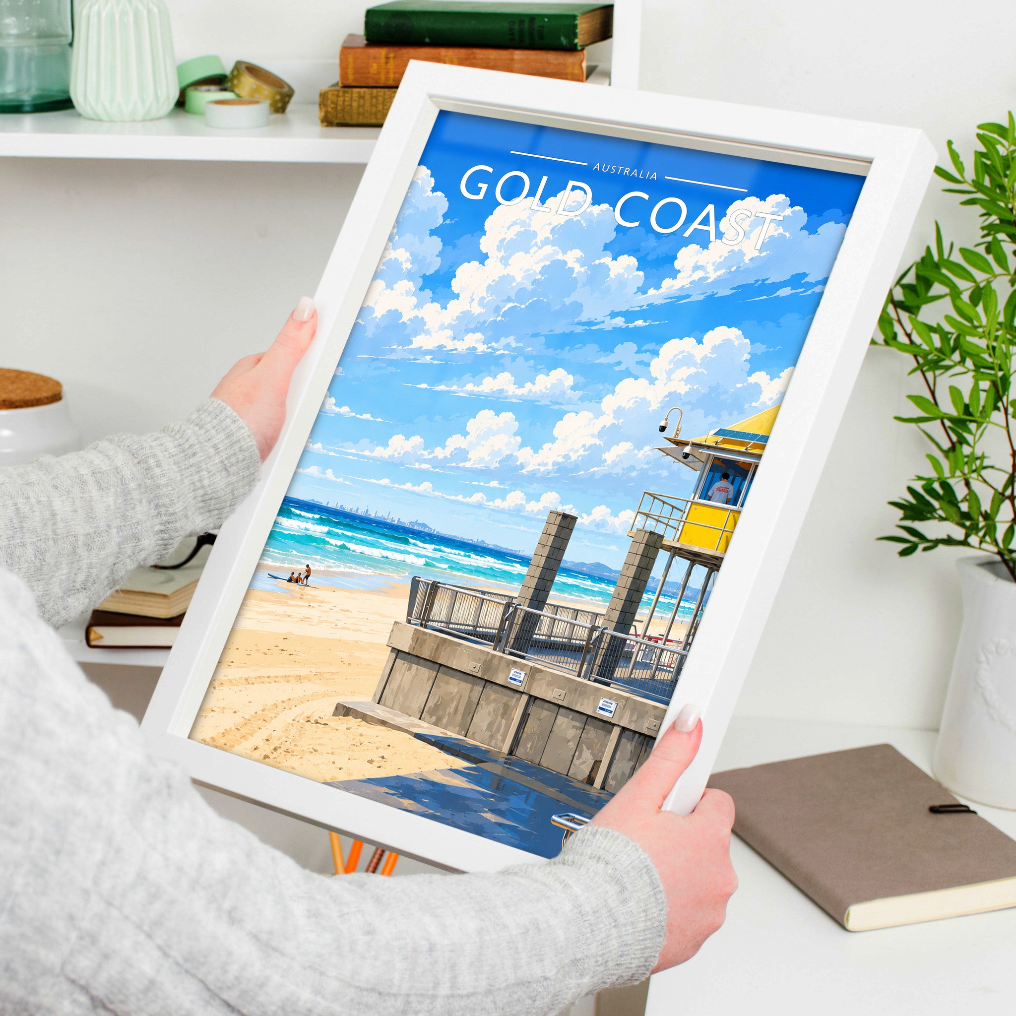 Gold Coast Travel Poster in a white frame, held to show scale