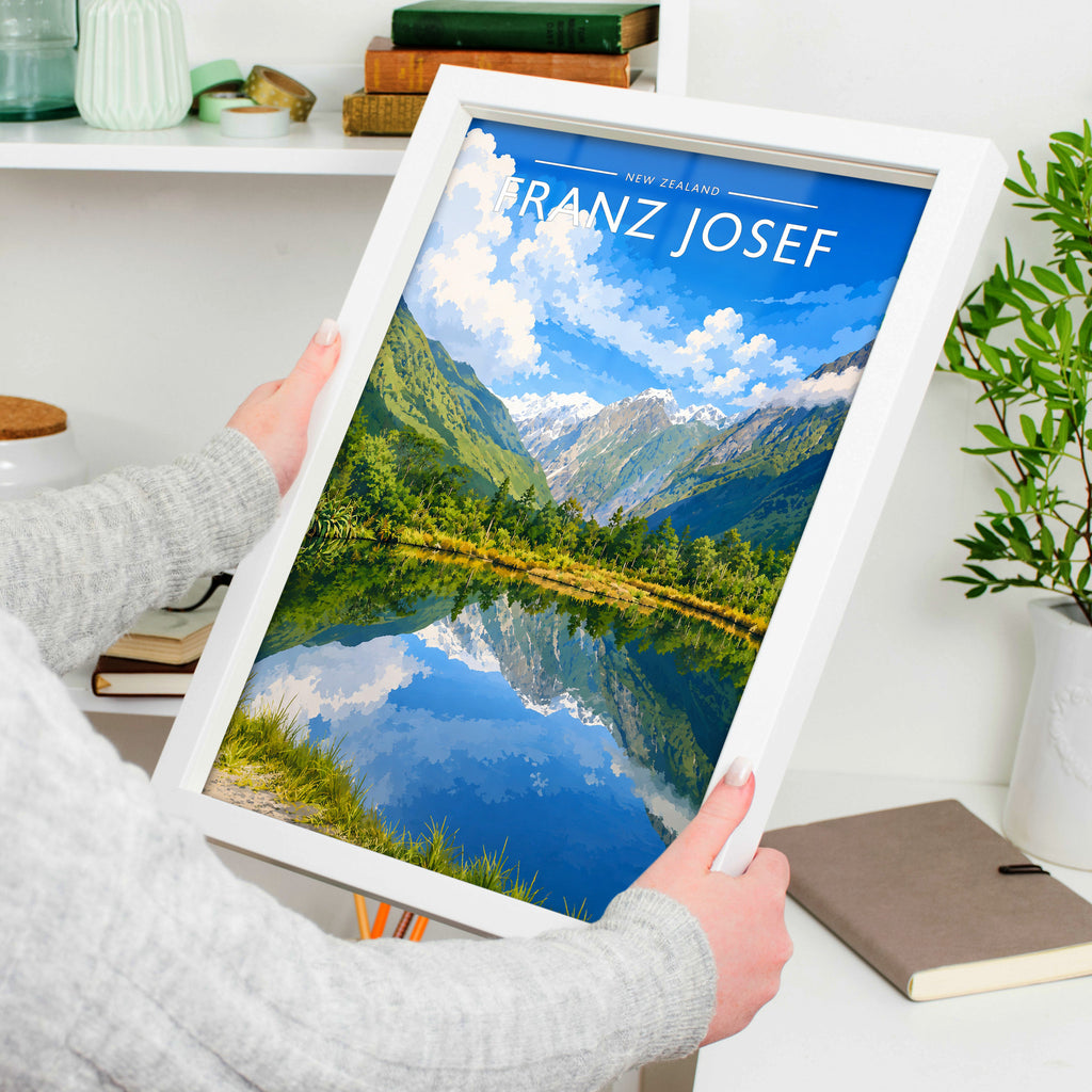 Franz Josef Travel Poster in a white frame, held to show scale