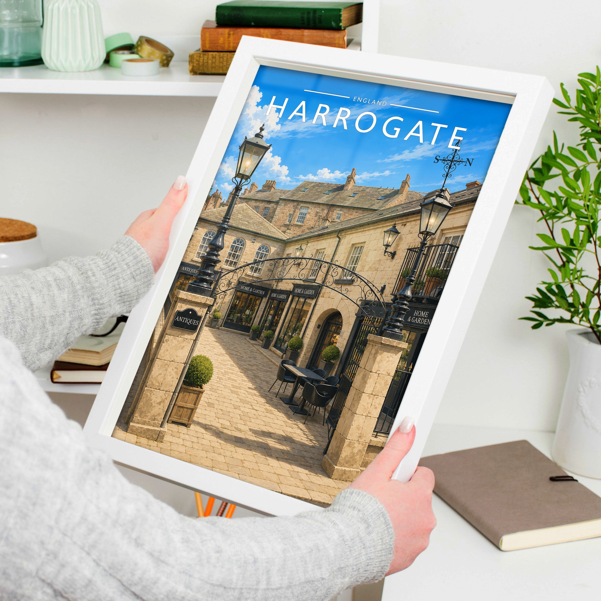 Harrogate Travel Poster in a white frame, held to show scale