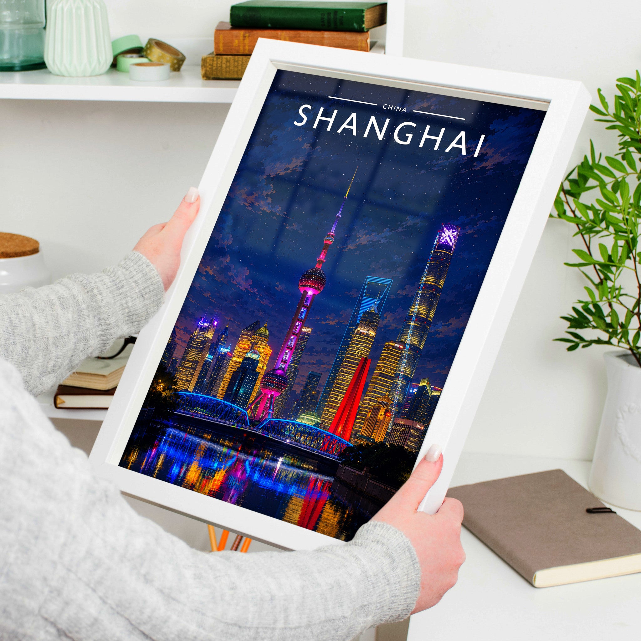Shanghai Travel Poster in a white frame, held to show scale
