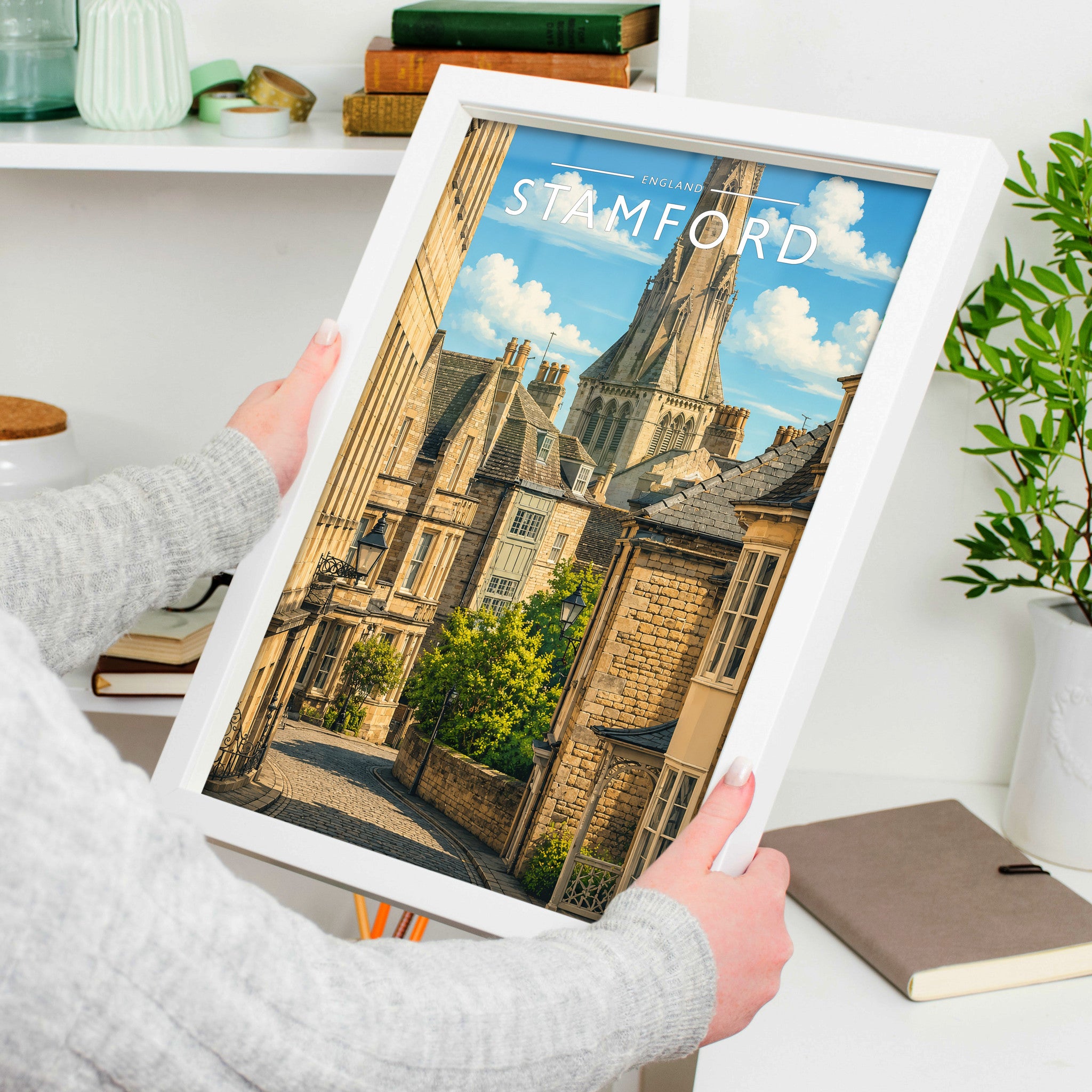 Stamford #13 Travel Poster in a white frame, held to show scale