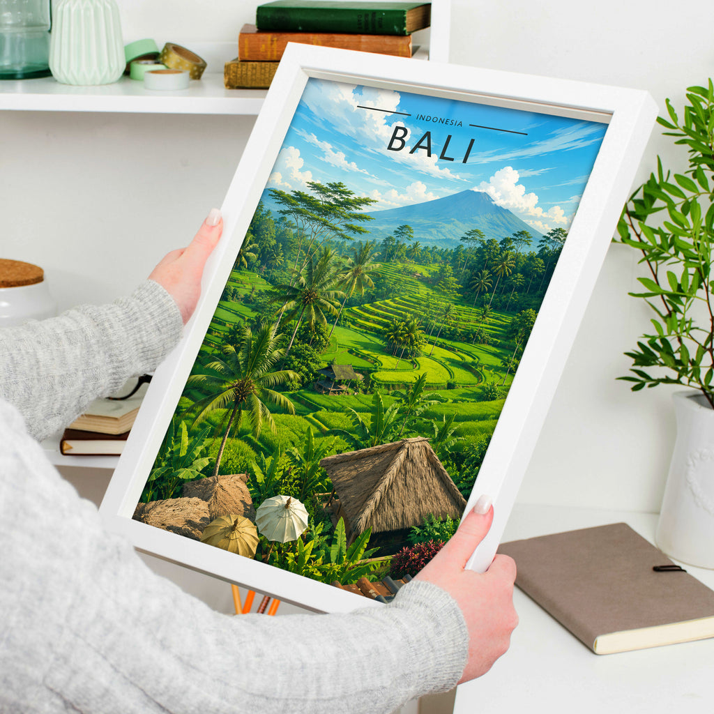 Bali Travel Poster in a white frame, held to show scale