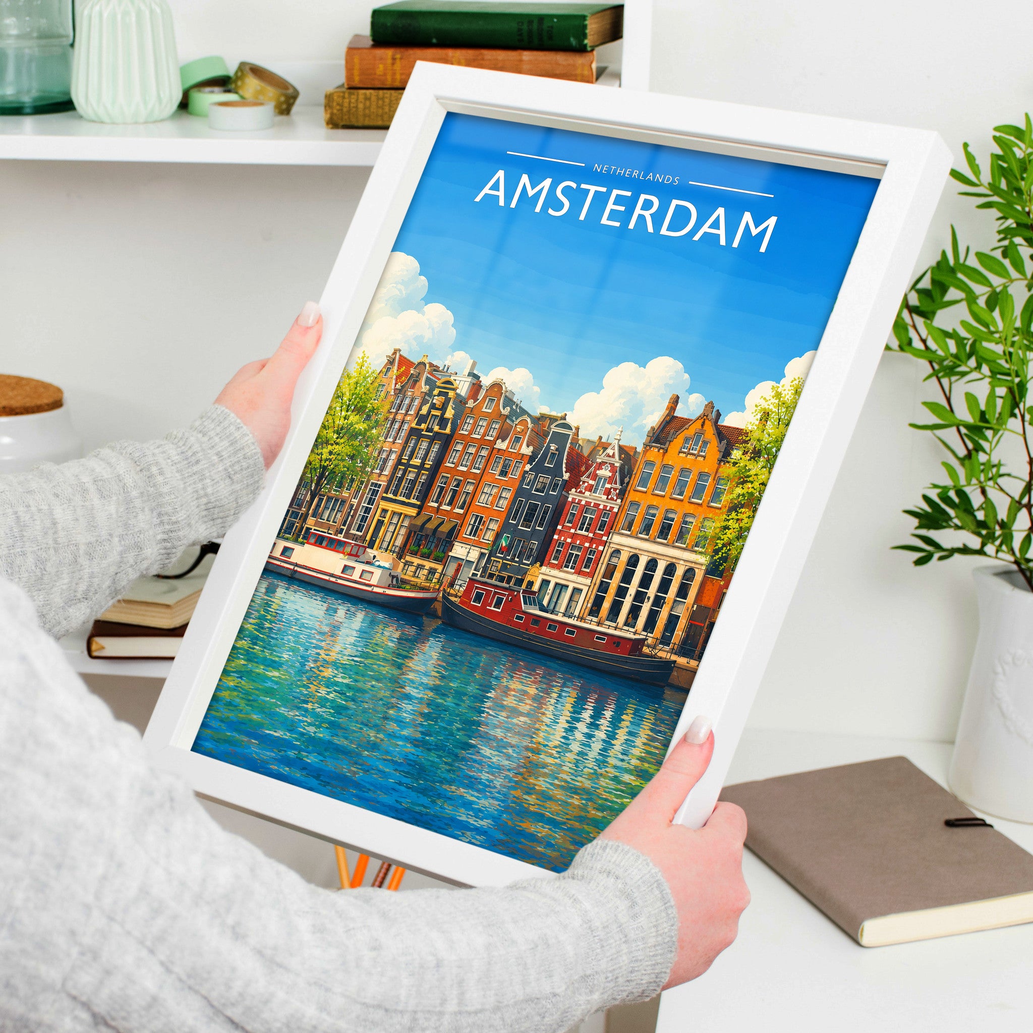 Amsterdam #5 Travel Poster in a white frame, held to show scale