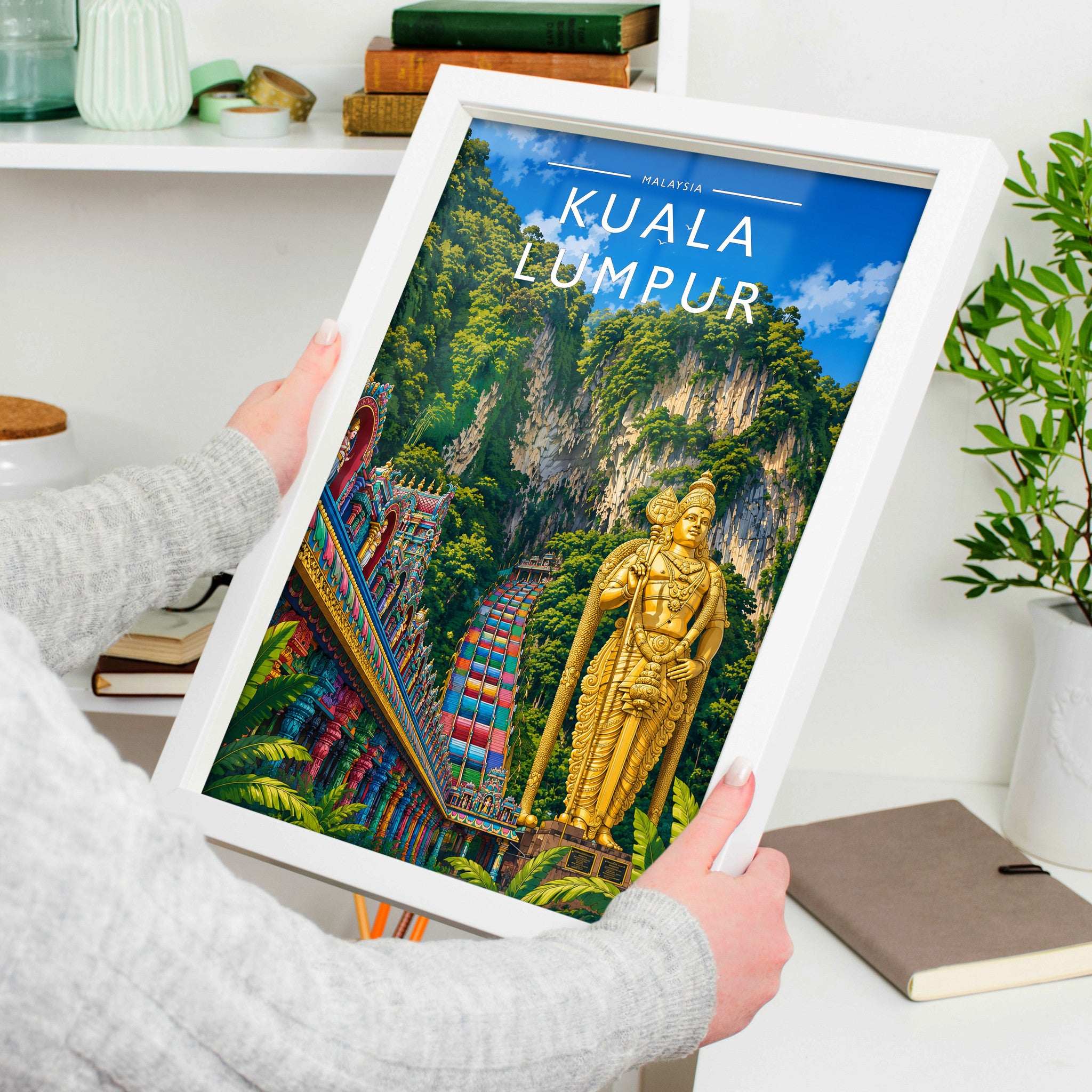 Kuala Lumpur Travel Poster in a white frame, held to show scale