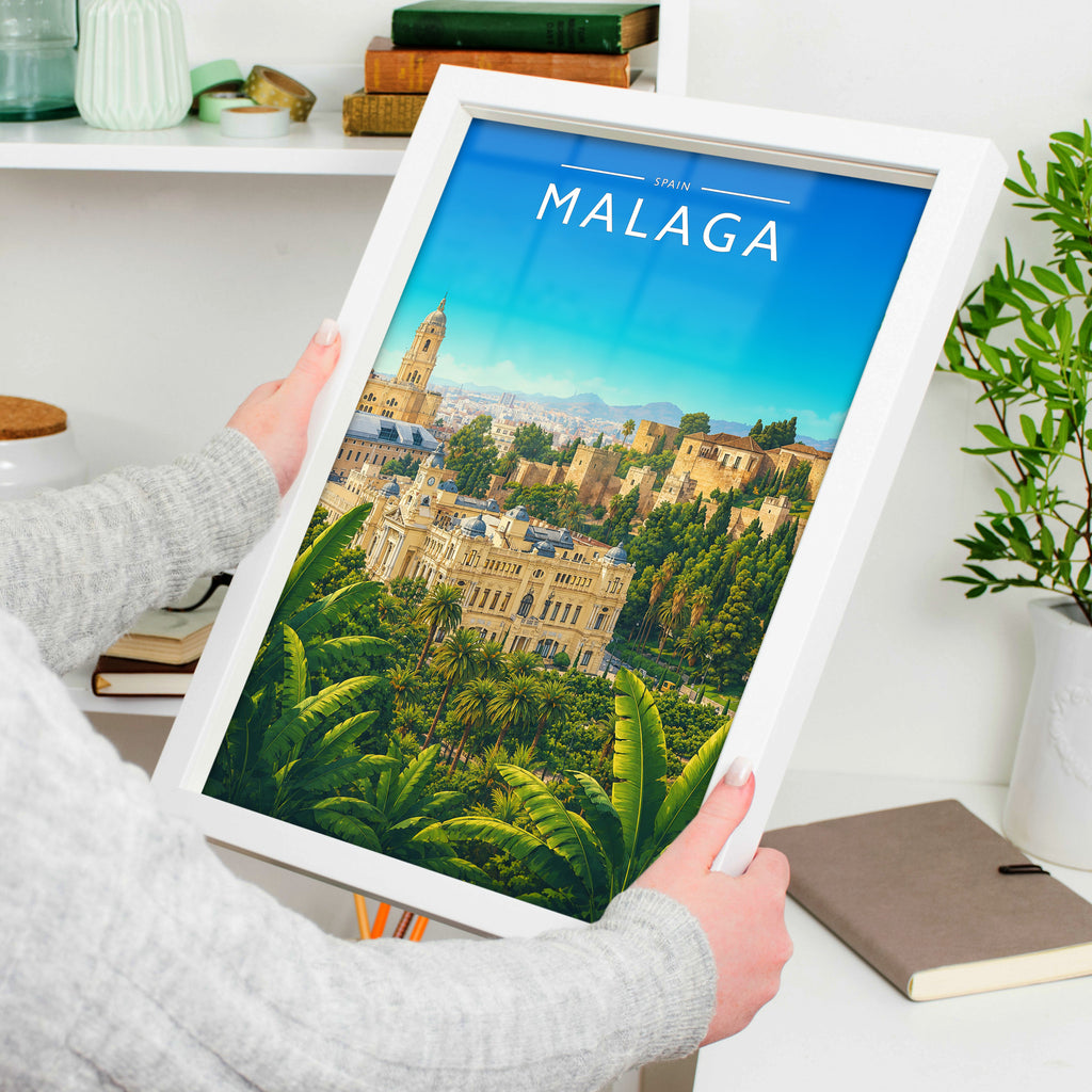 Malaga #3 Travel Poster in a white frame, held to show scale