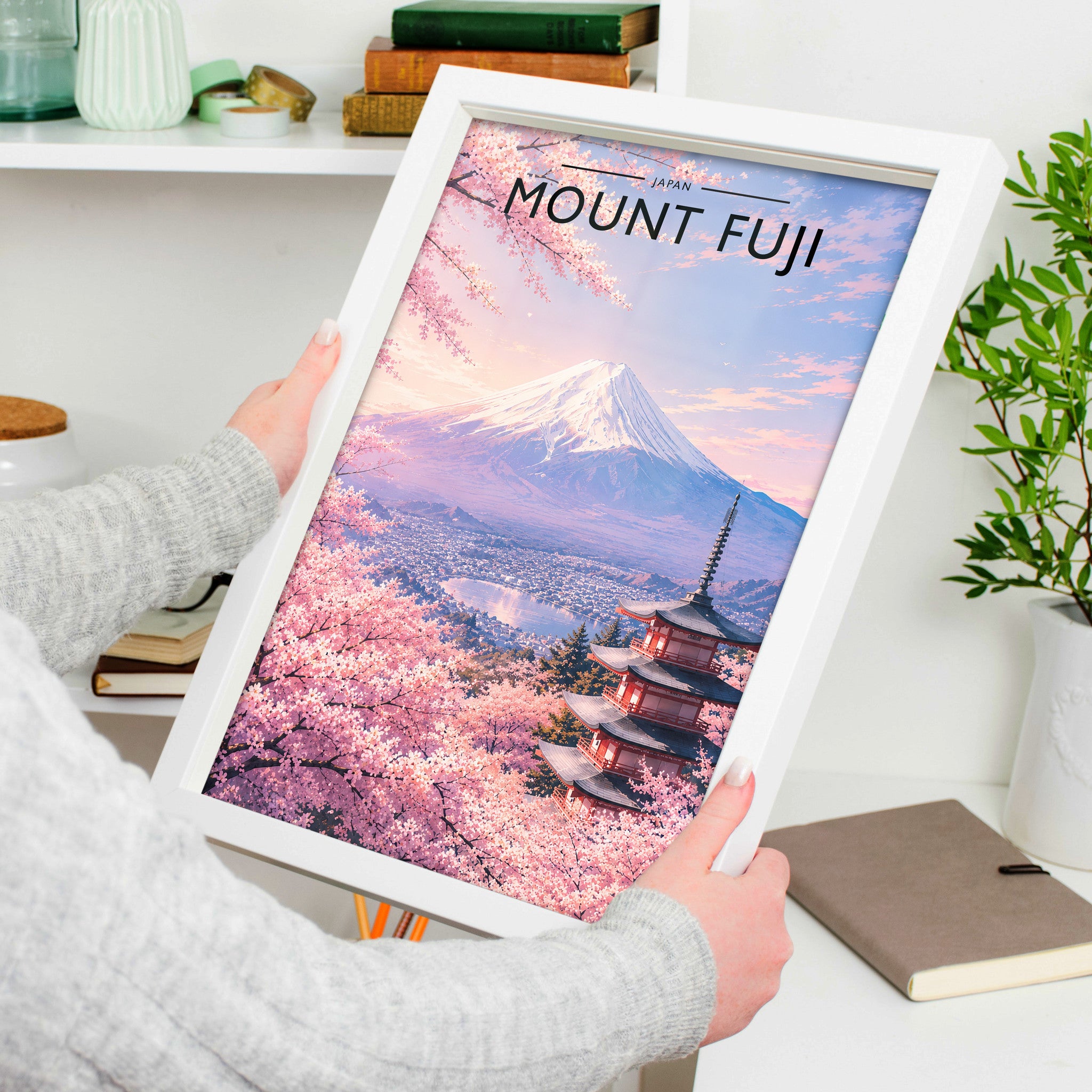 Mount Fuji Travel Poster in a white frame, held to show scale