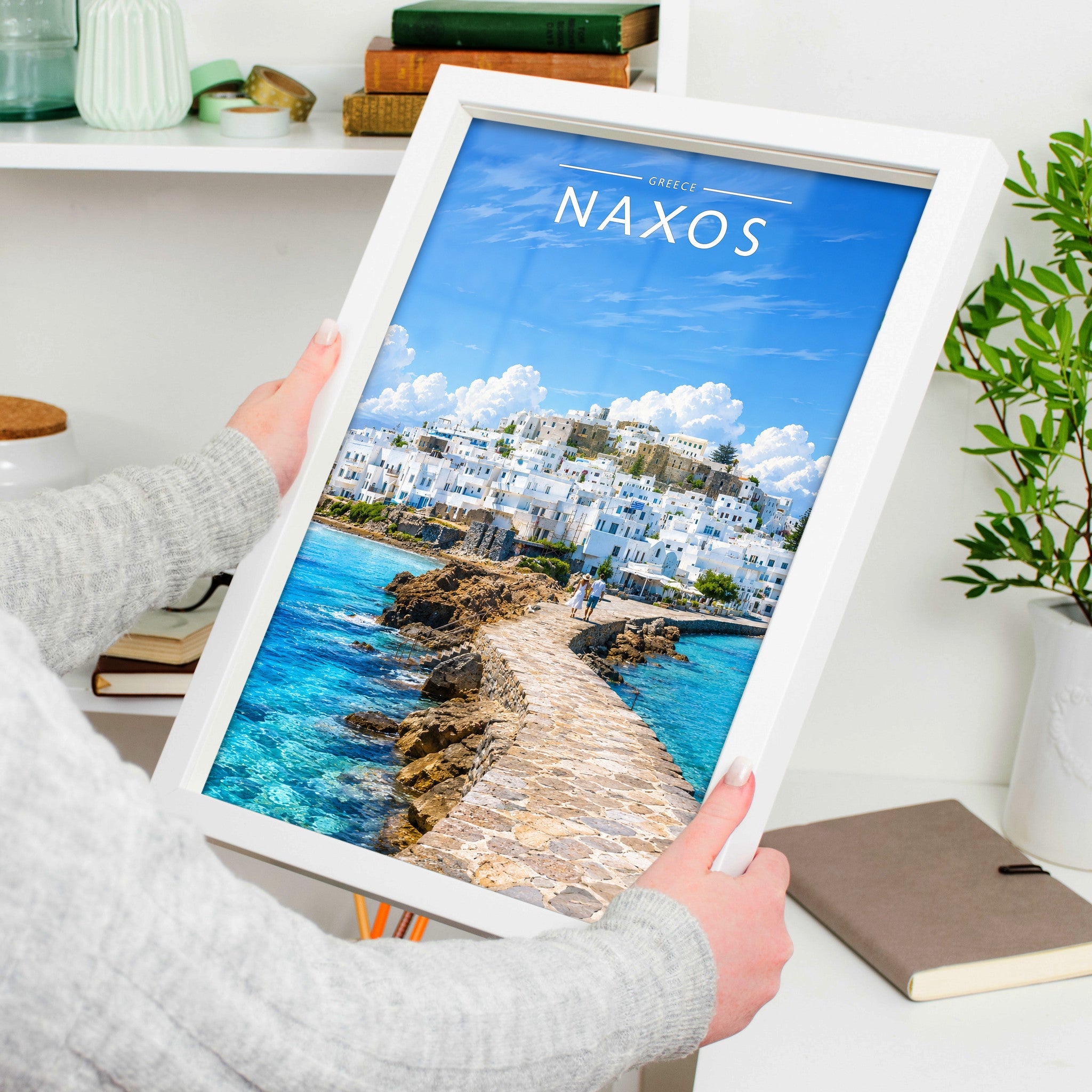 Naxos Travel Poster in a white frame, held to show scale