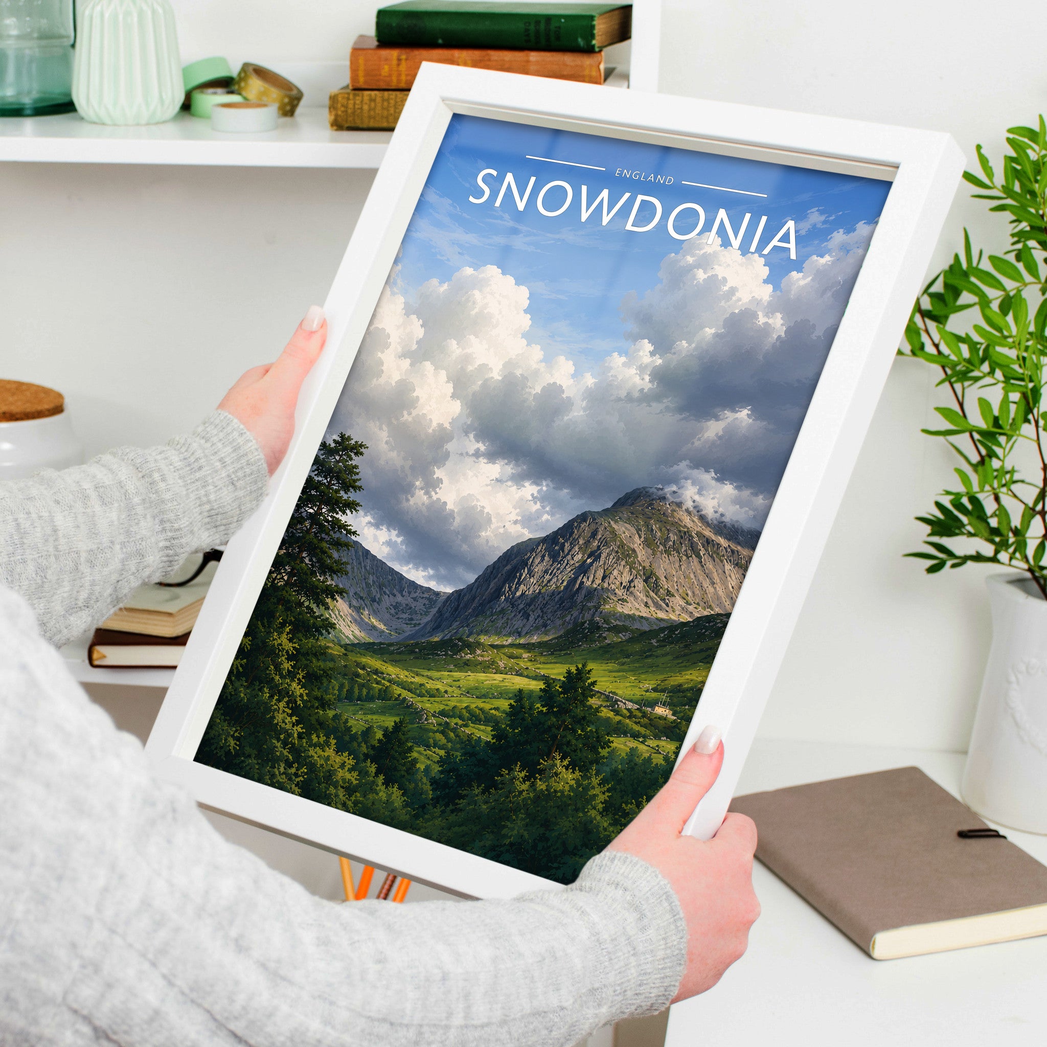 Snowdonia Travel Poster in a white frame, held to show scale