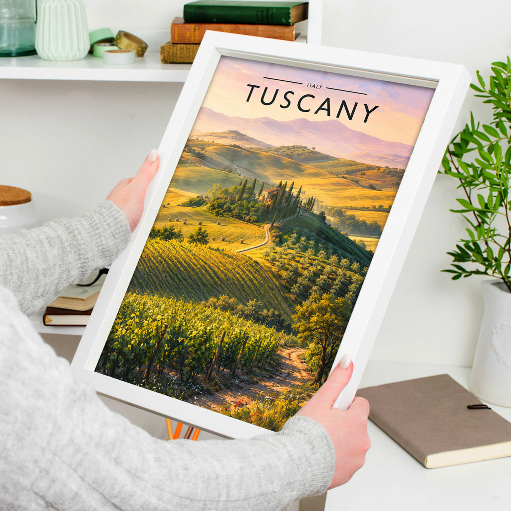 Tuscany Travel Poster in a white frame, held to show scale