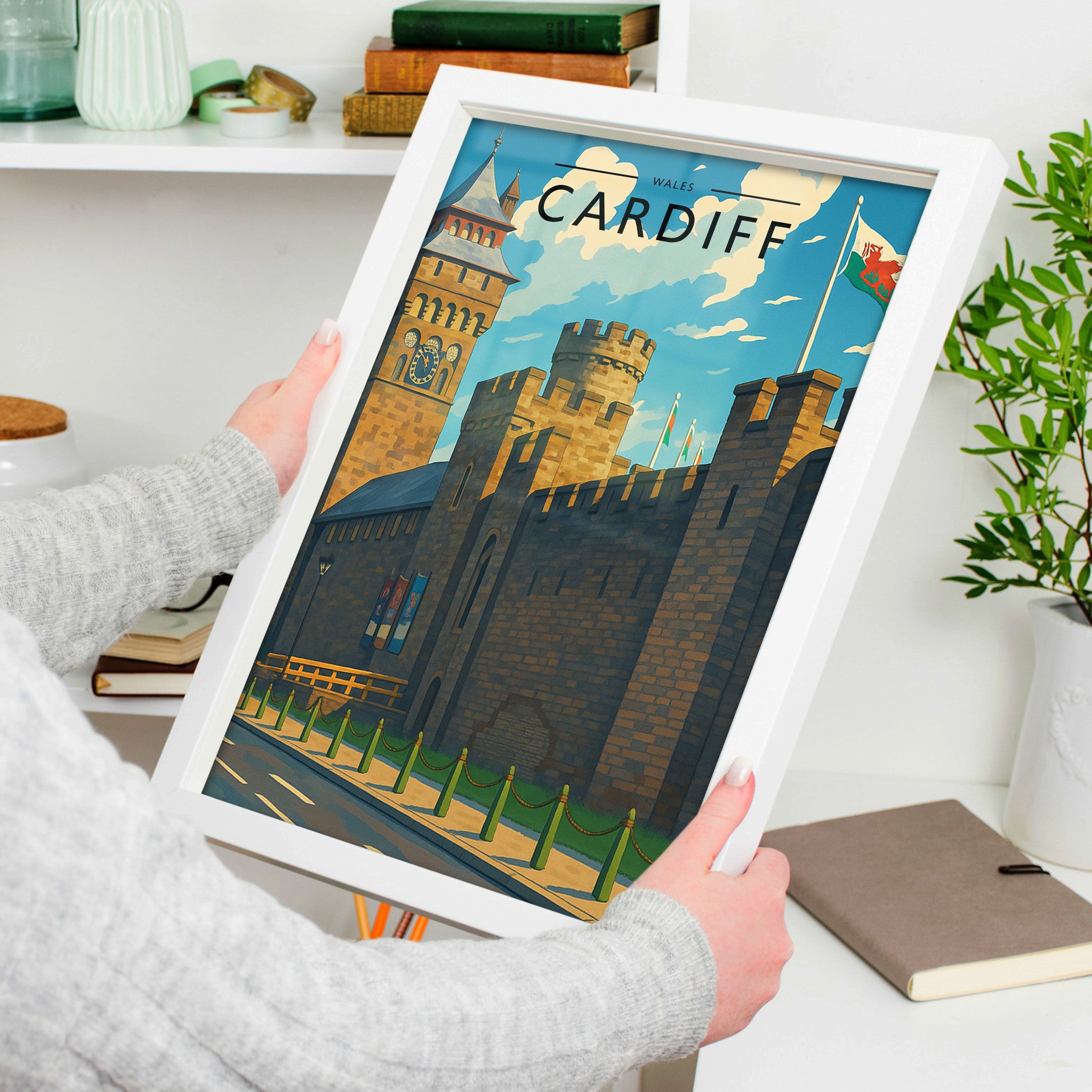 Cardiff Travel Poster in a white frame, held to show scale