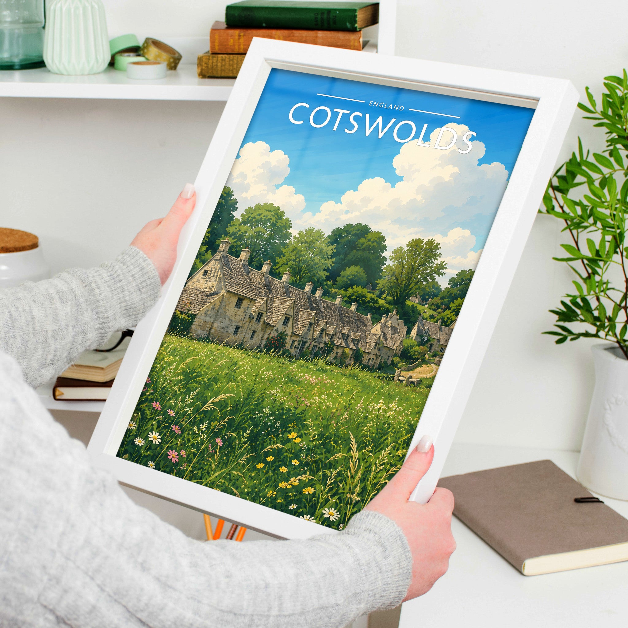 Cotswolds Travel Poster in a white frame, held to show scale