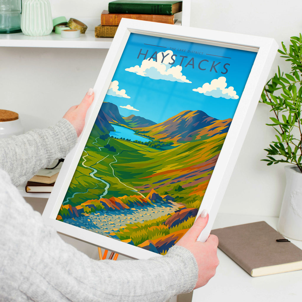 Haystacks Travel Poster in a white frame, held to show scale