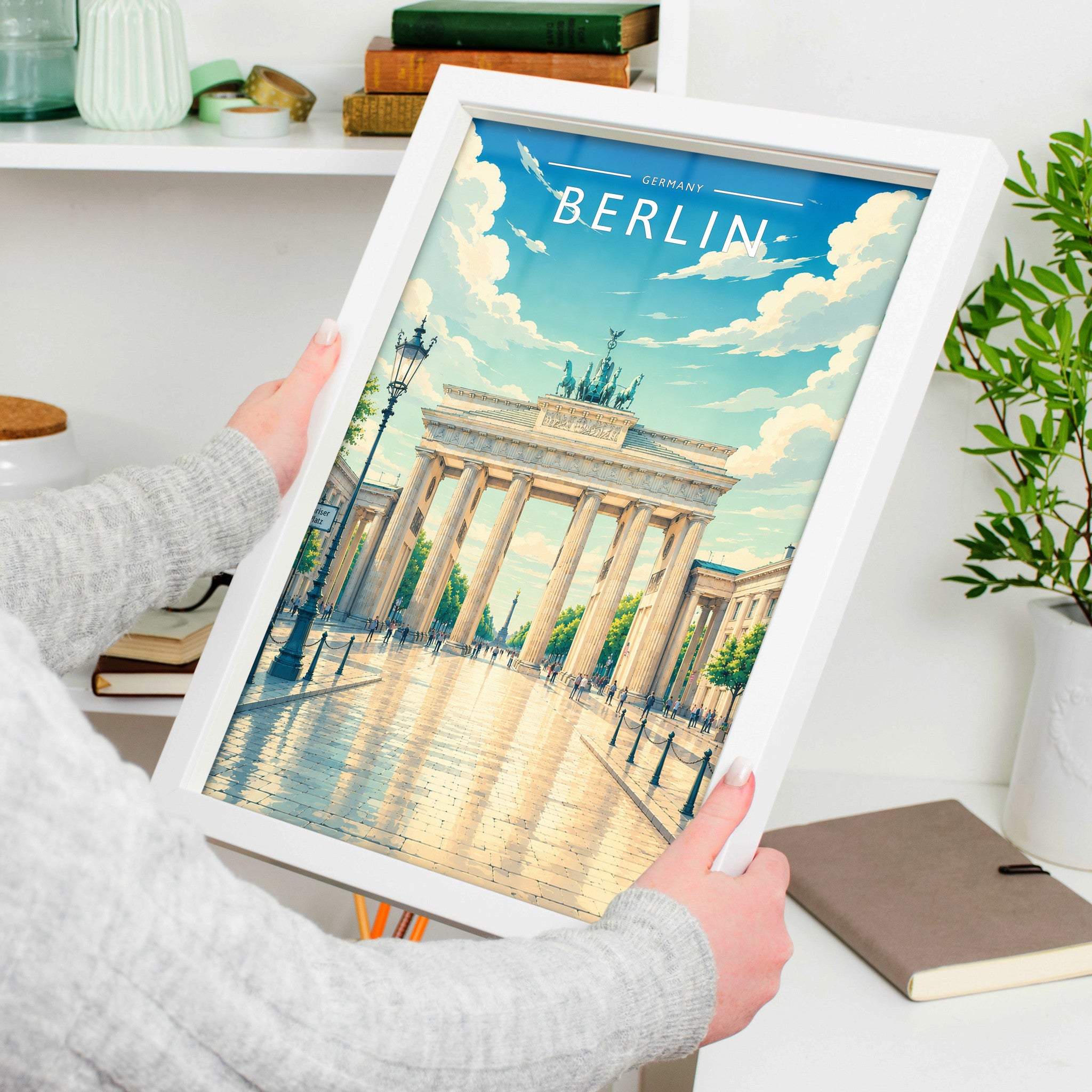 Berlin #2 Travel Poster in a white frame, held to show scale