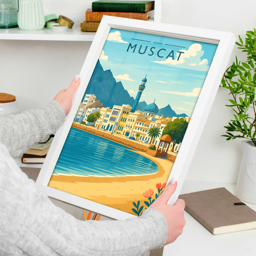 Muscat Travel Poster in a white frame, held to show scale