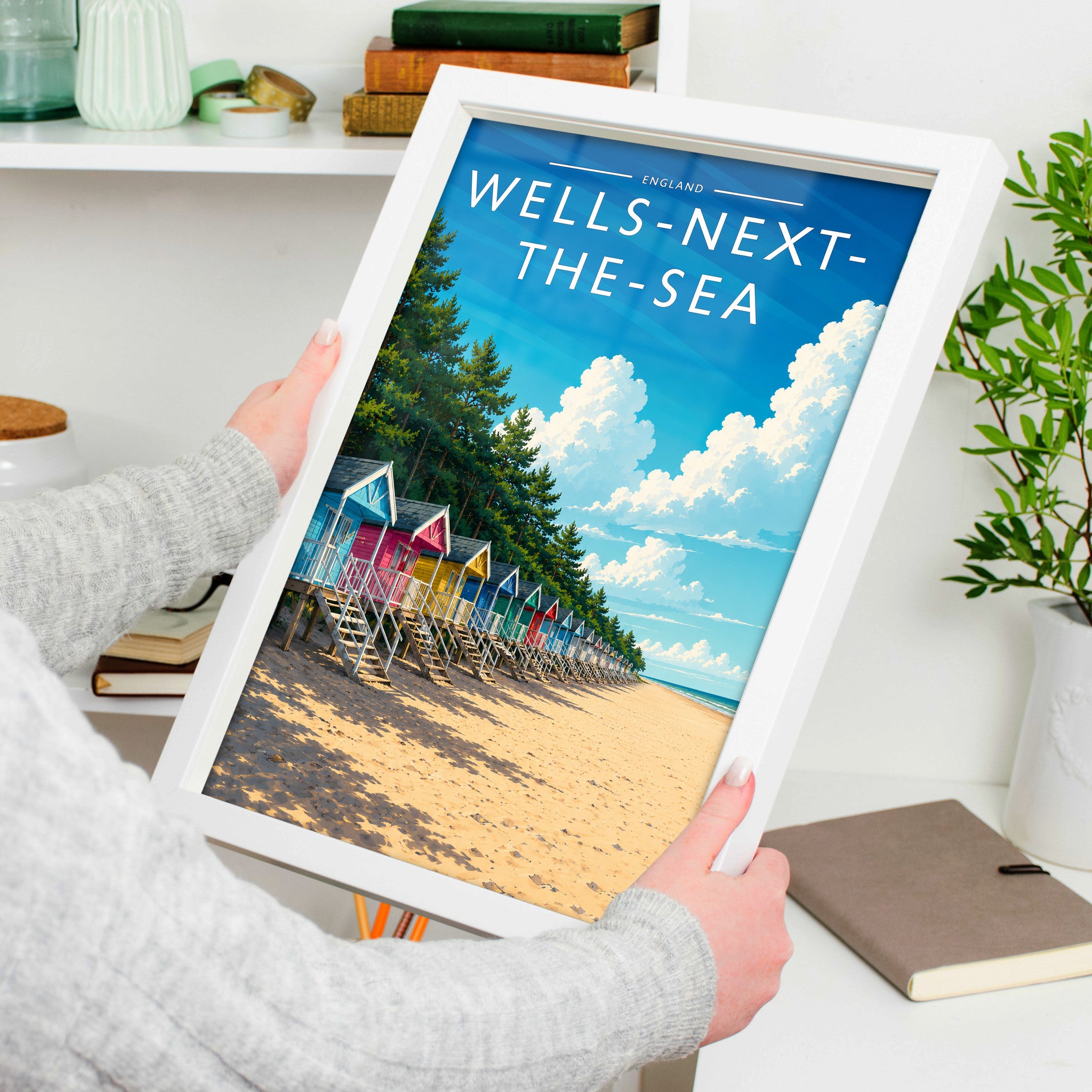 Wells-next-the-Sea #3 Travel Poster in a white frame, held to show scale