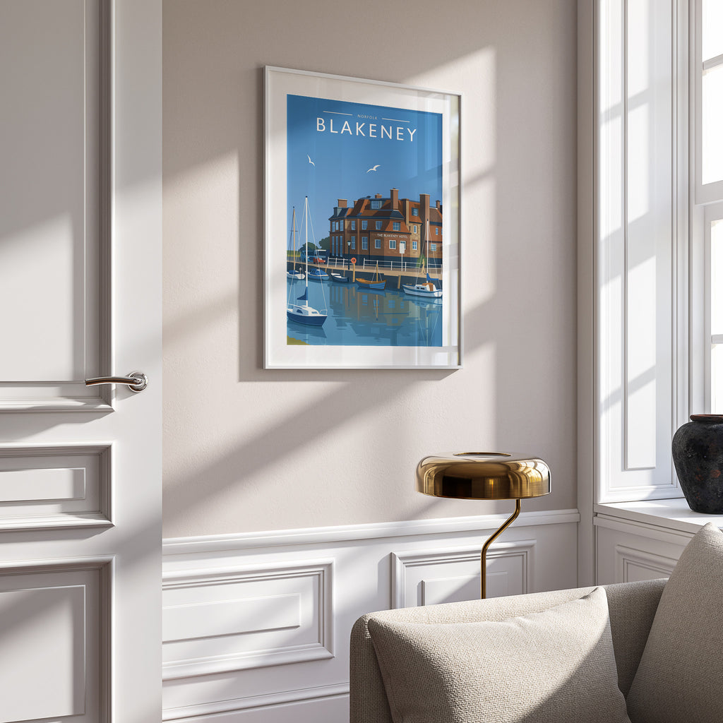 Blakeney Travel Poster in a white frame on a panelled wall