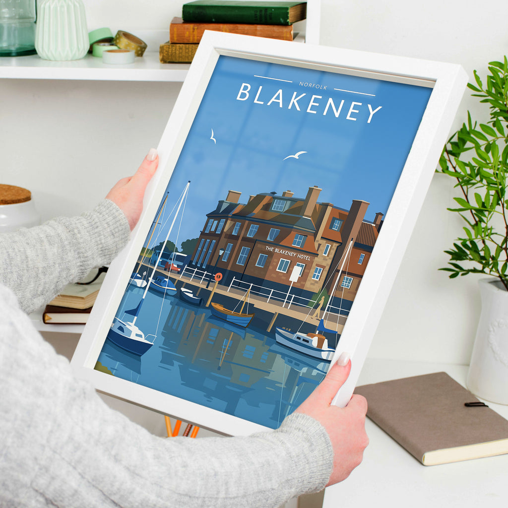 Blakeney Travel Poster in a white frame, held to show scale
