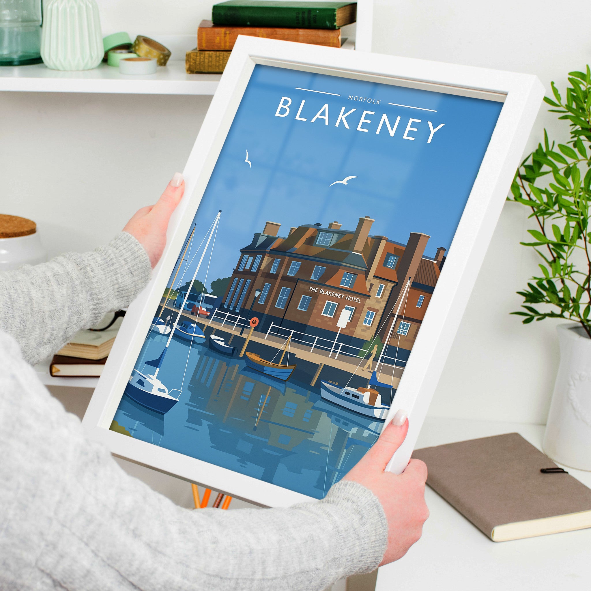 Blakeney Travel Poster in a white frame, held to show scale