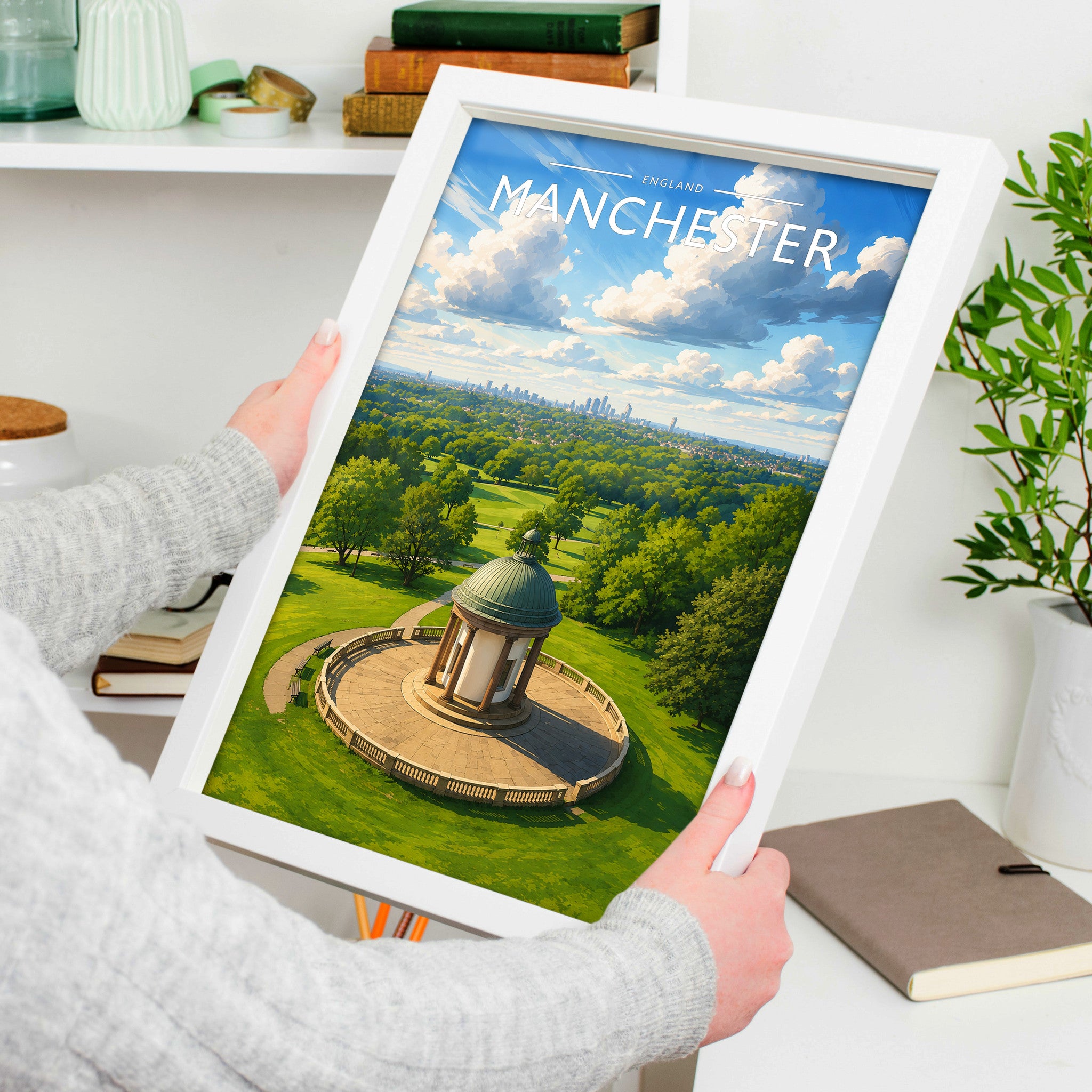 Manchester #2 Travel Poster in a white frame, held to show scale