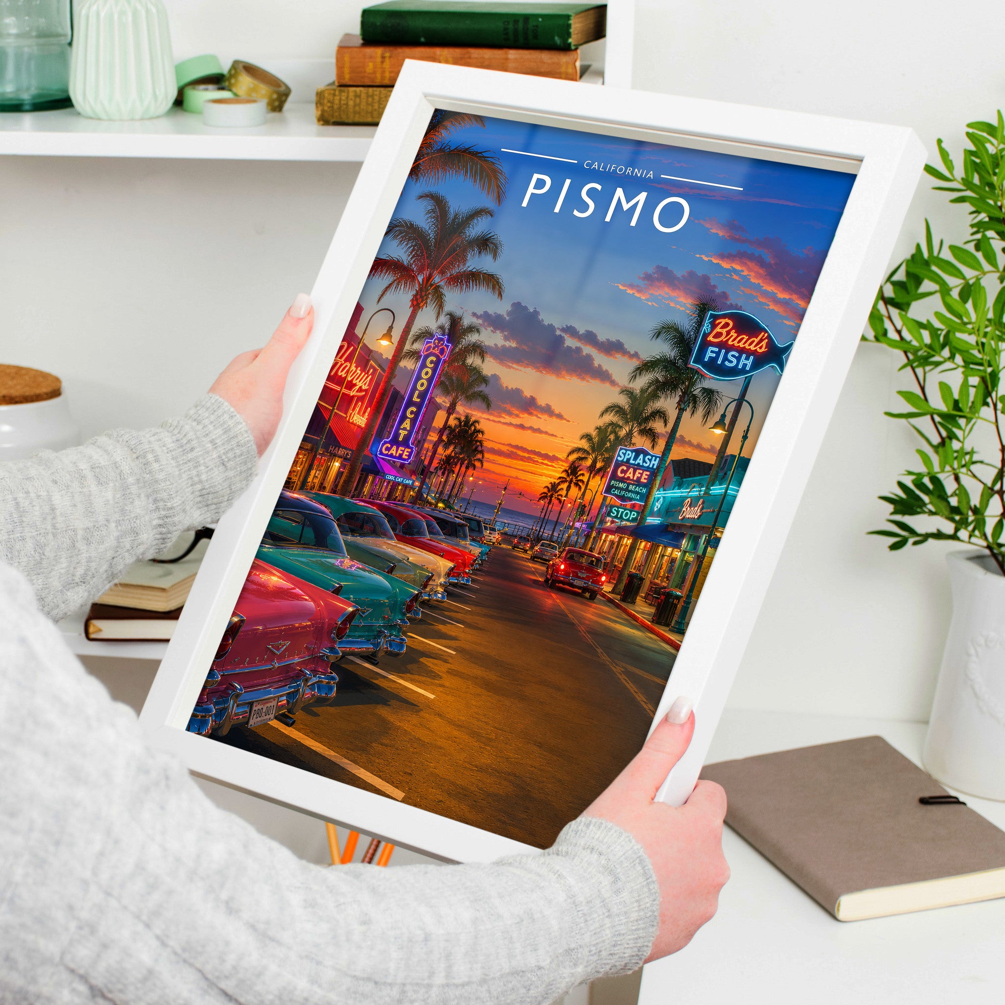 Pismo Travel Poster in a white frame, held to show scale