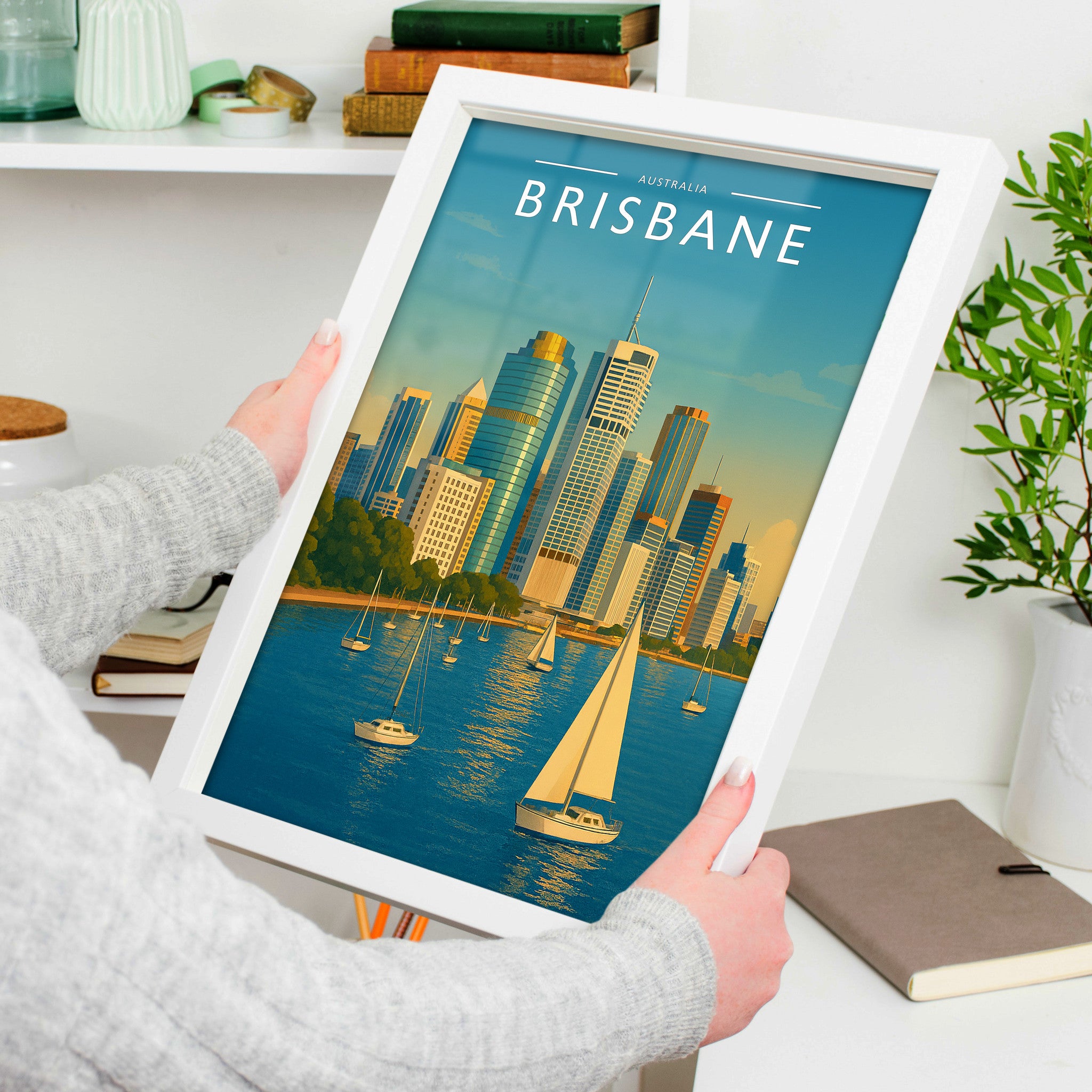 Brisbane Travel Poster in a white frame, held to show scale