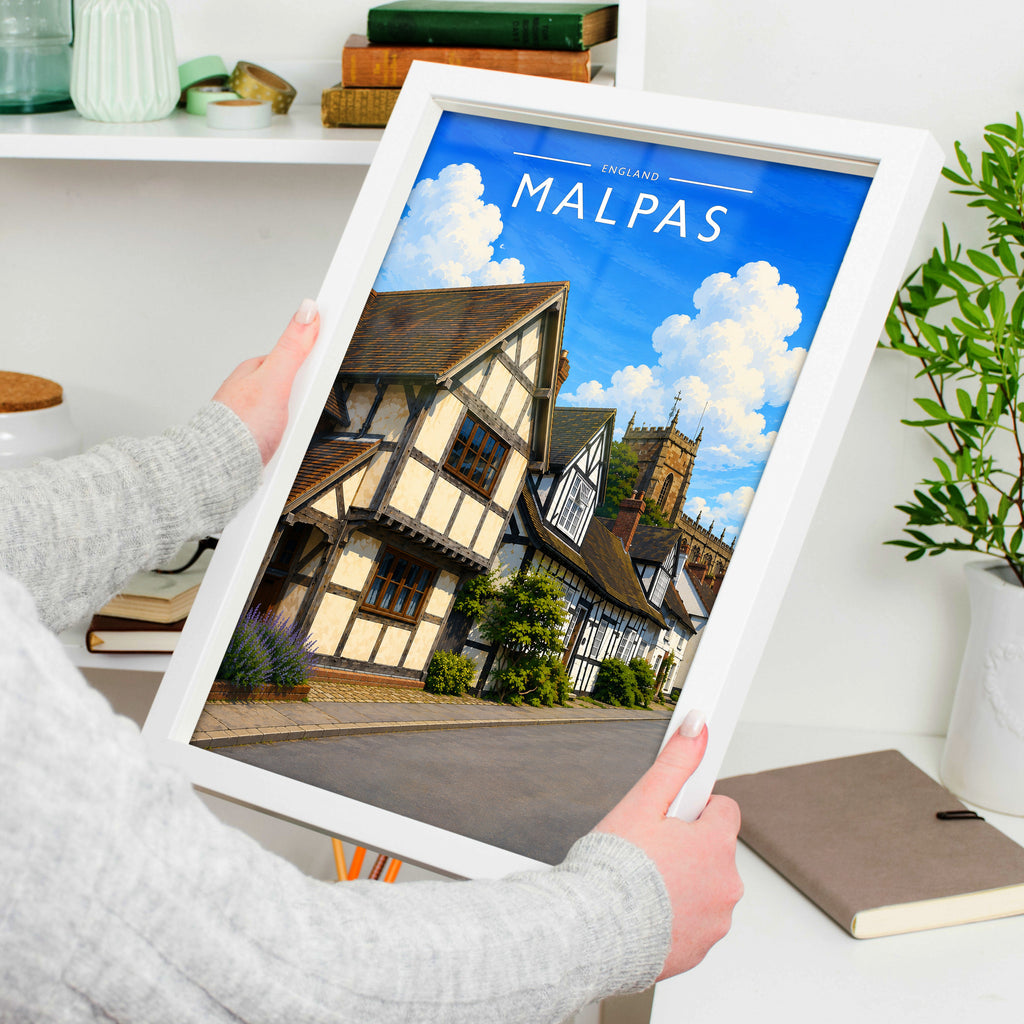 Malpas Travel Poster in a white frame, held to show scale