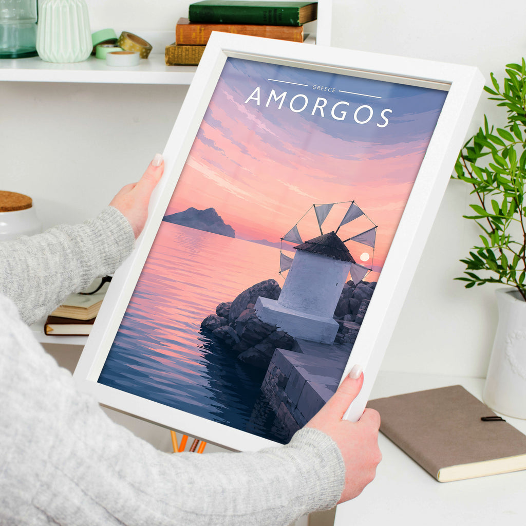 Amorgos Travel Poster in a white frame, held to show scale