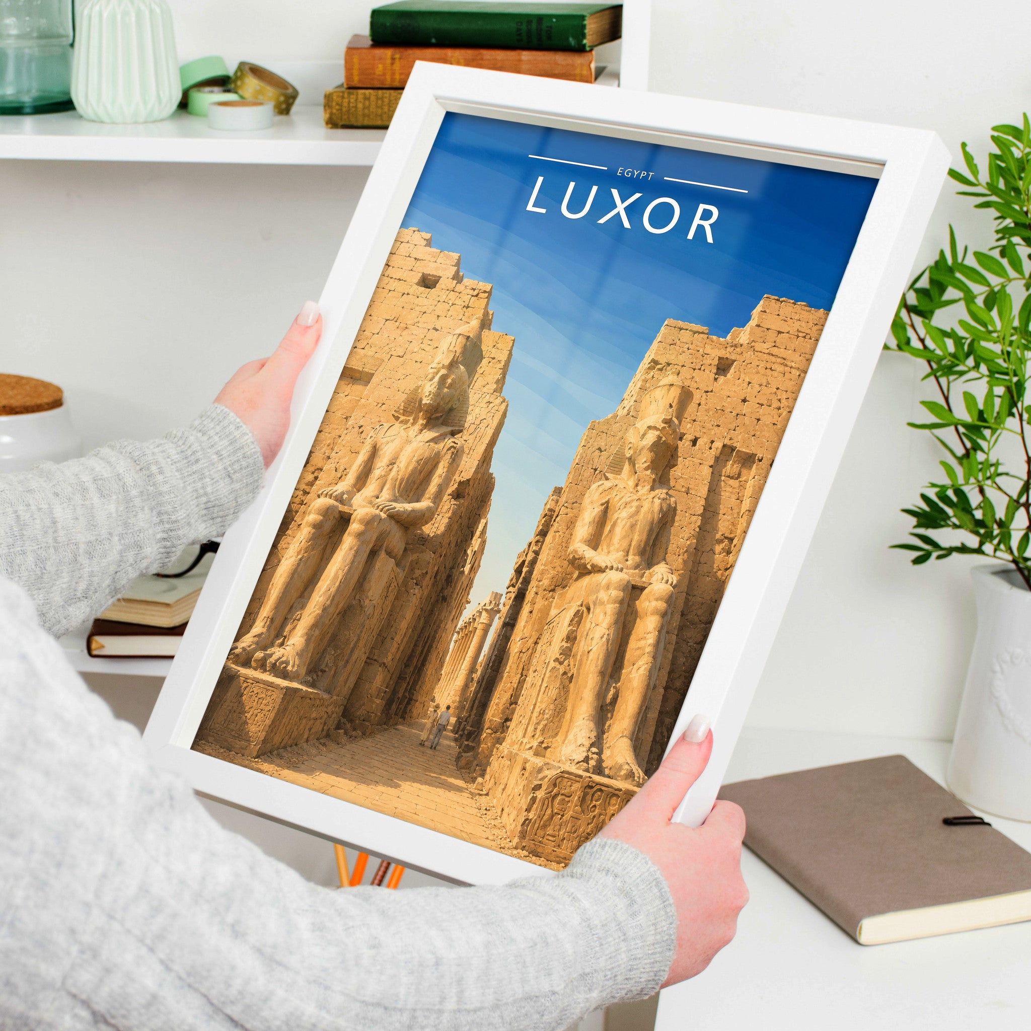 Luxor Travel Poster in a white frame, held to show scale