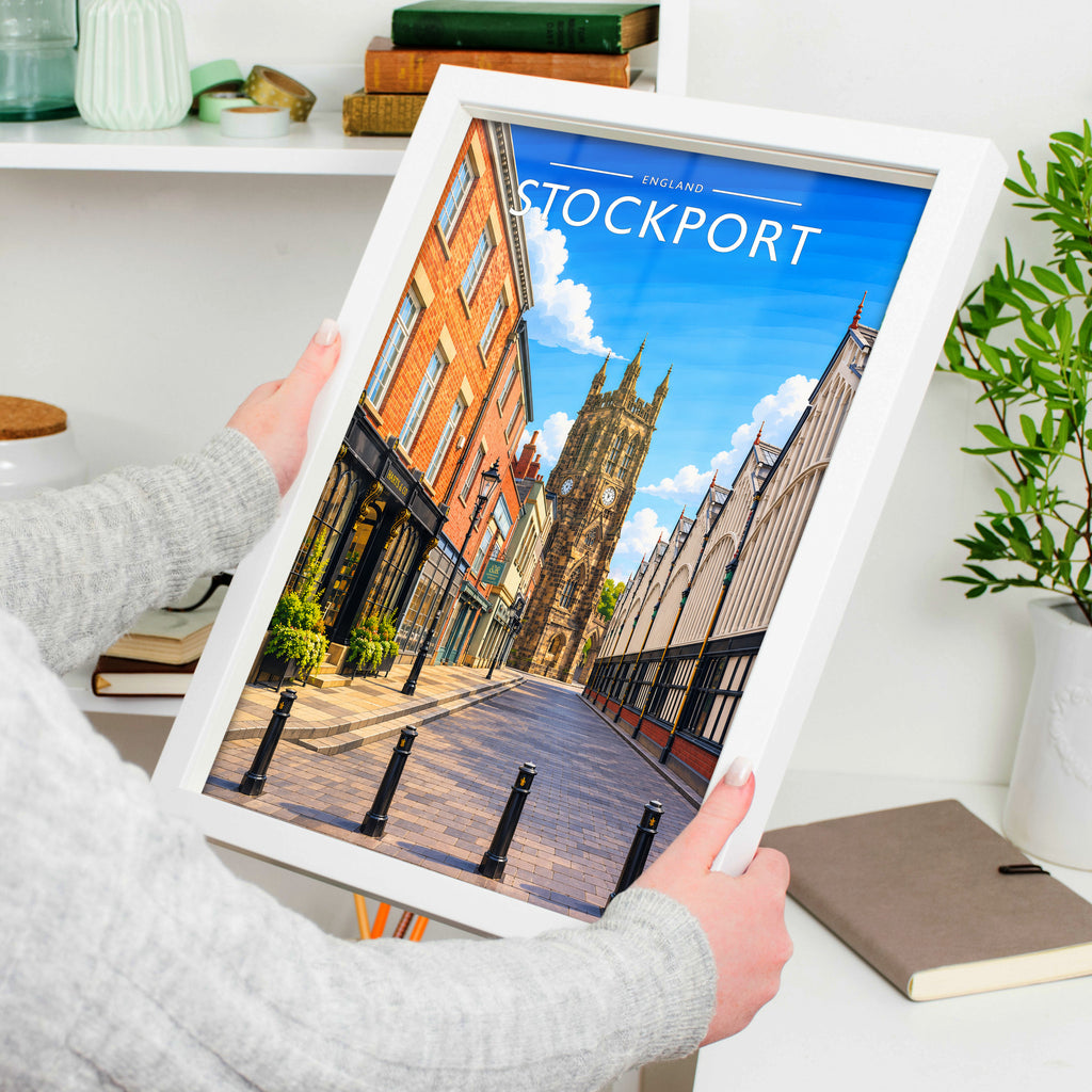 Stockport Travel Poster in a white frame, held to show scale