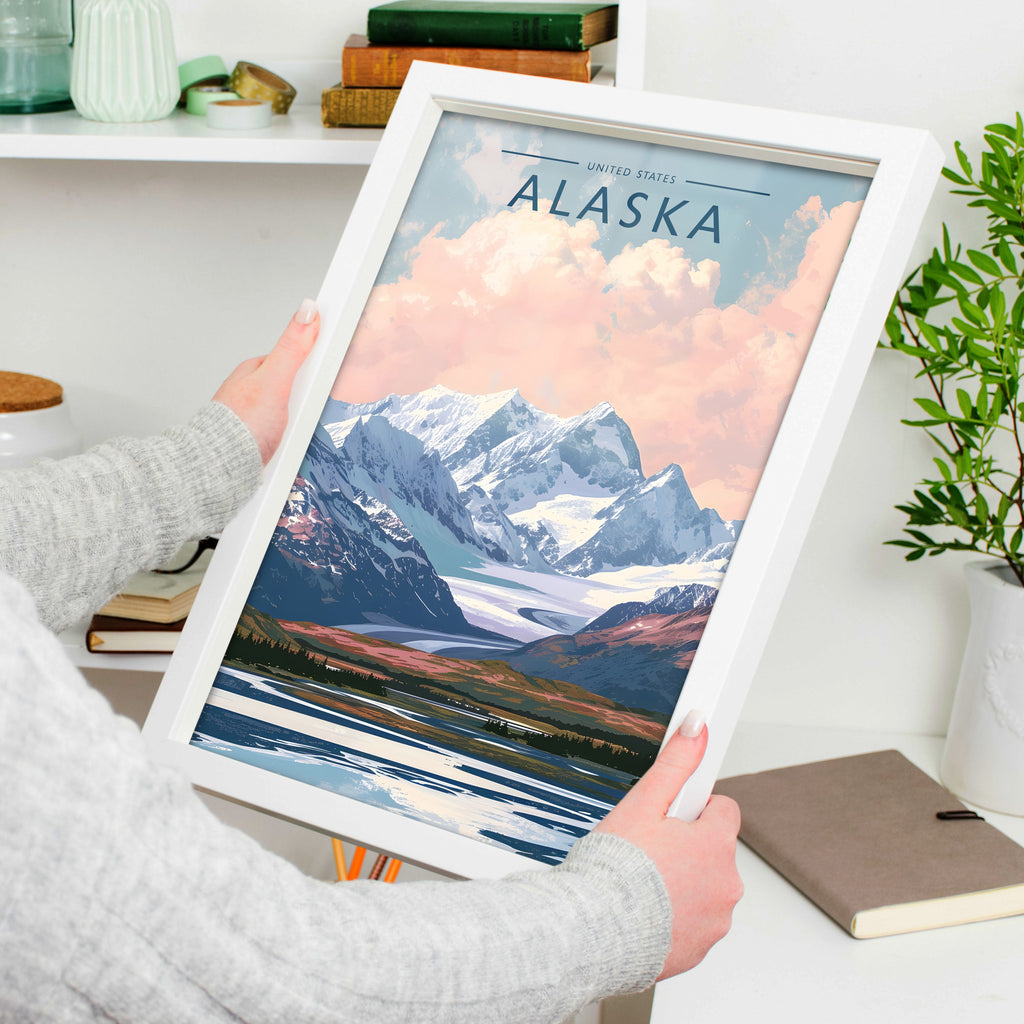 Alaska Travel Poster in a white frame, held to show scale