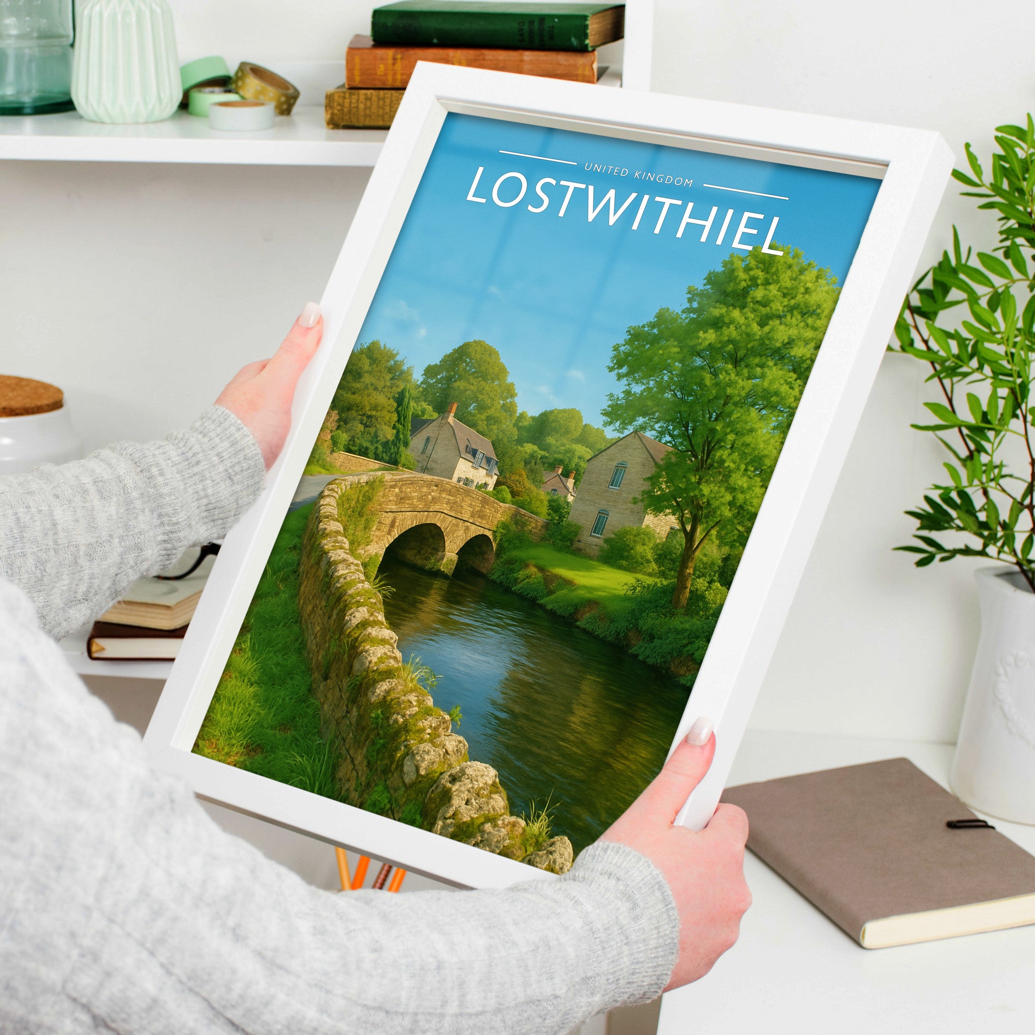 Lostwithiel Travel Poster in a white frame, held to show scale